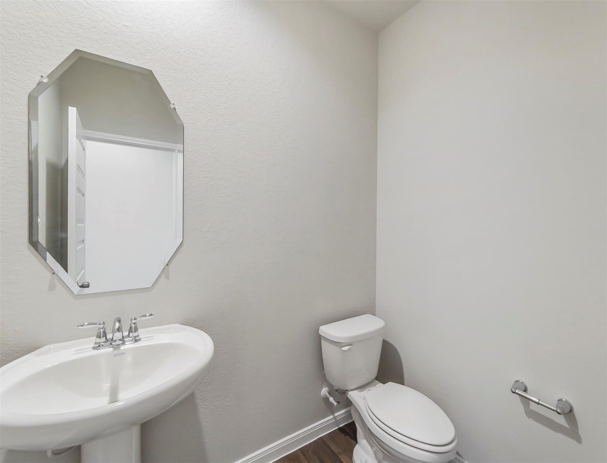 Conveniently located downstairs half bath for guests.