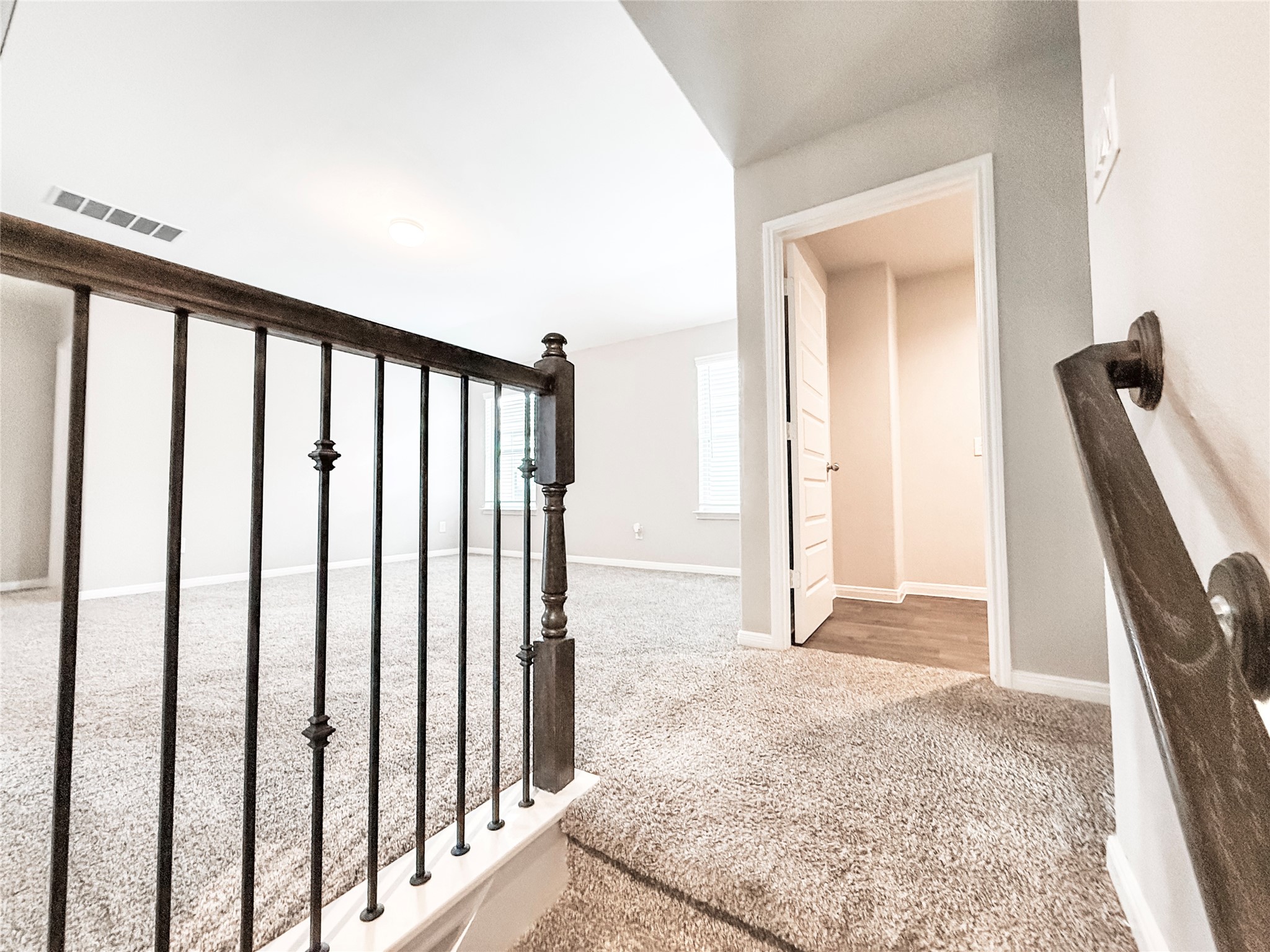 Stairway opens to a spacious game room and additional living space. Across the hall is the conveniently located laundry area!