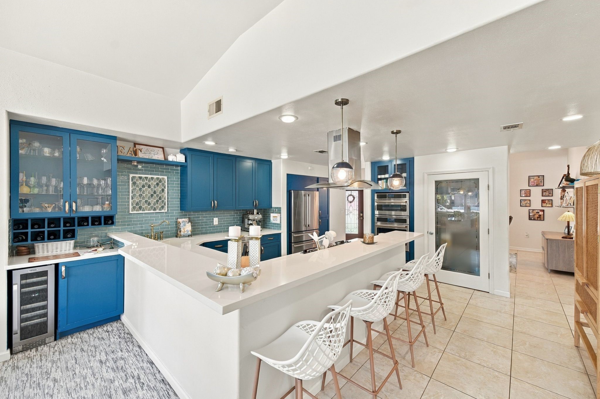 Conveniently located adjacent to the kitchen, this stylish bar area features a separate beverage refrigerator, making it the perfect spot for preparing refreshments and entertaining guests with ease.