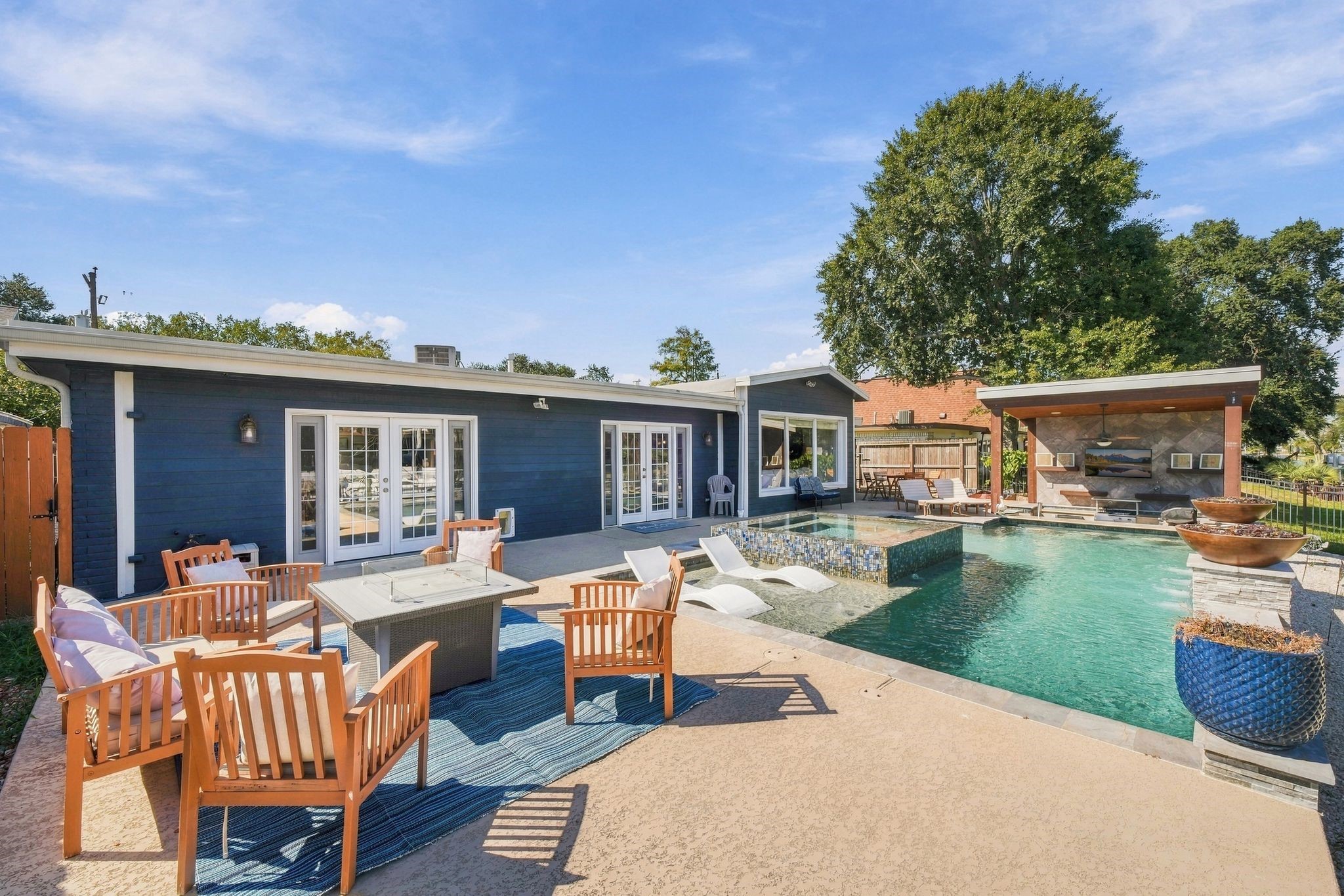 This backyard oasis offers spacious patio seating, and a modern outdoor kitchen, and firepit for those cool crisp evenings. This backyard oasis offers spacious patio seating, and a modern outdoor kitchen, and firepit for those cool crisp evenings.