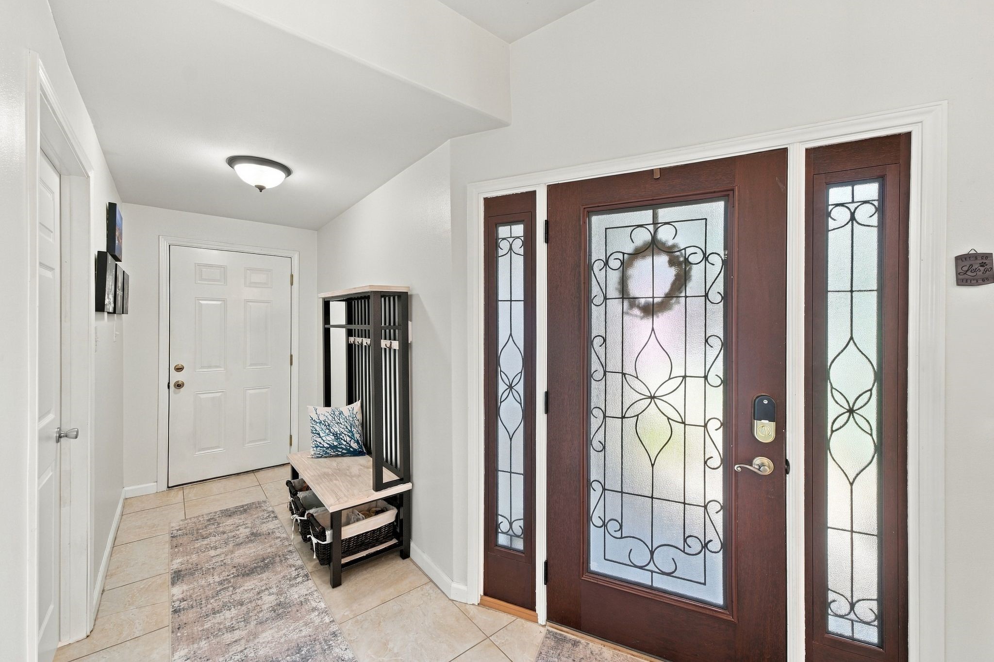 Welcoming entryway featuring elegant glass-paneled double doors that fill the space with natural light. This versatile area offers the perfect opportunity to create a functional mudroom, with convenient access to the garage. Welcoming entryway featuring elegant glass-paneled double doors that fill the space with natural light. This versatile area offers the perfect opportunity to create a functional mudroom, with convenient access to the garage.