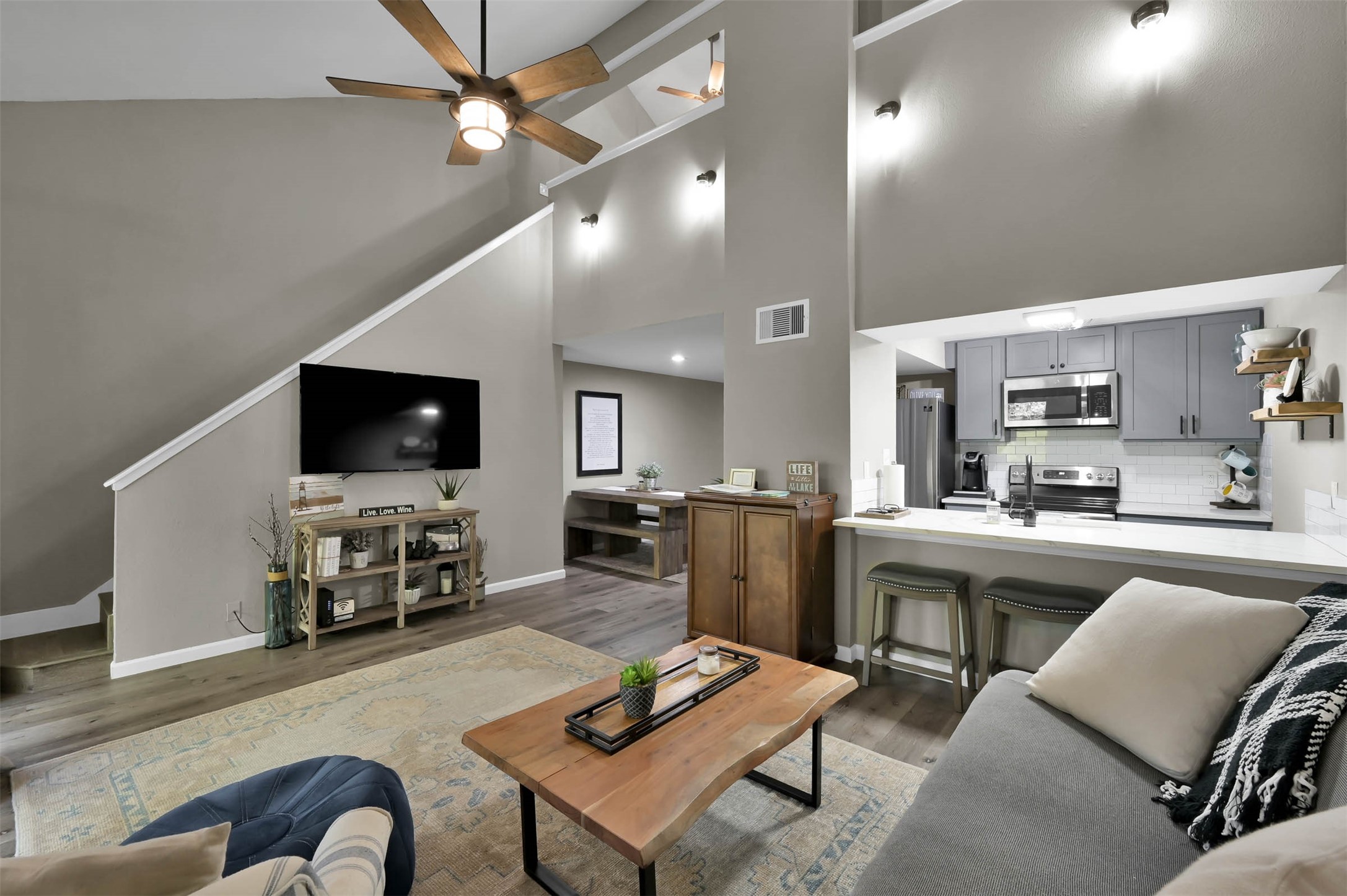 Living room looking toward kitchen and stairs