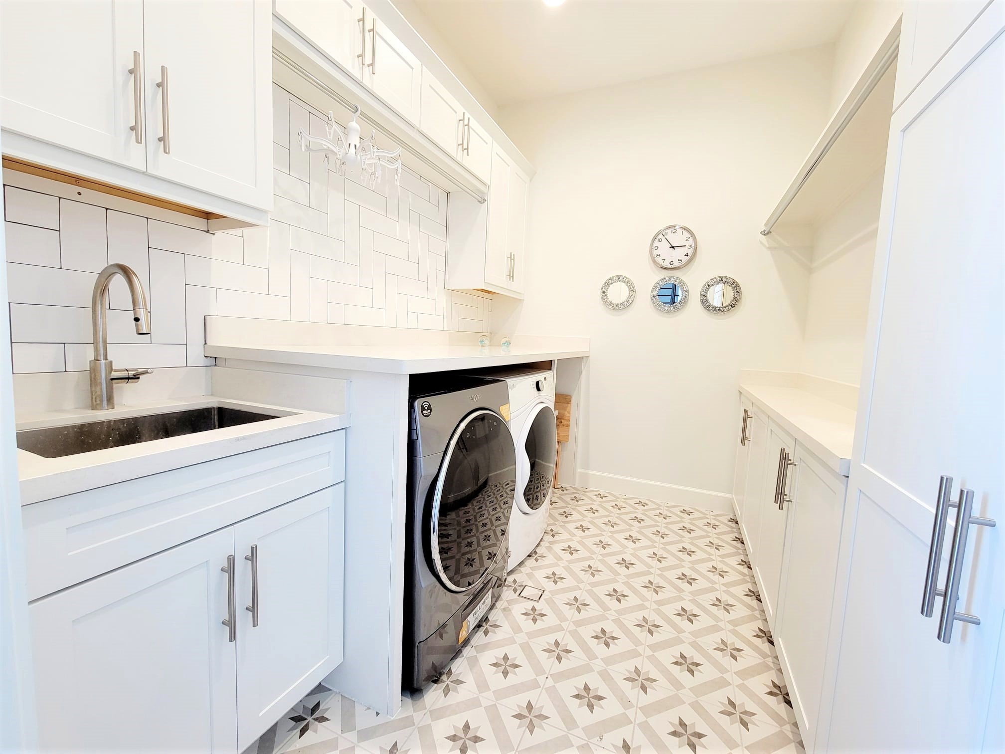 Large Laundry Room with auto soap refill washing machine, wifi capable. Enjoy extra space for folding station, storage and a deep s.s. sink!