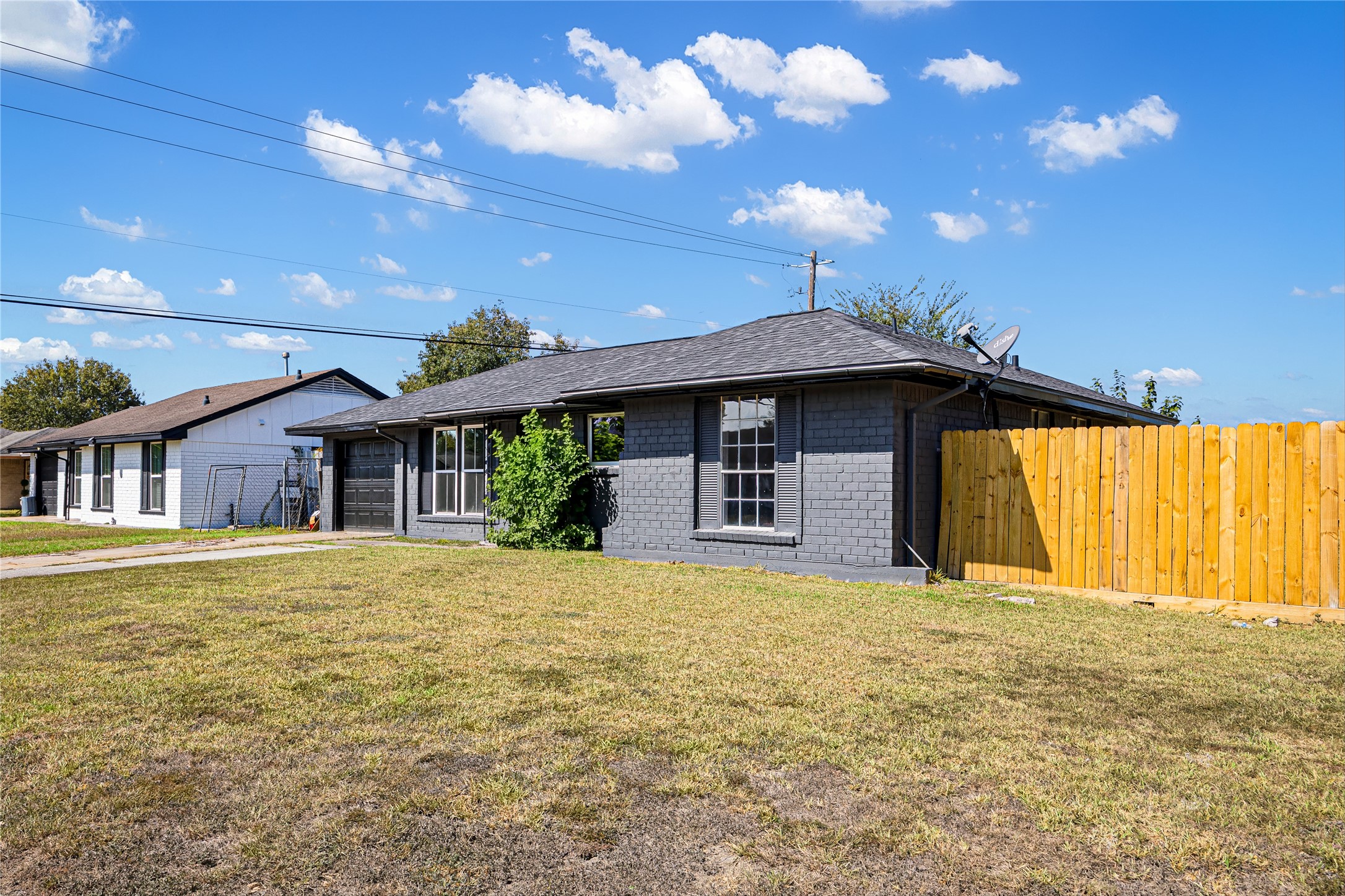 Side of home with brand new fence