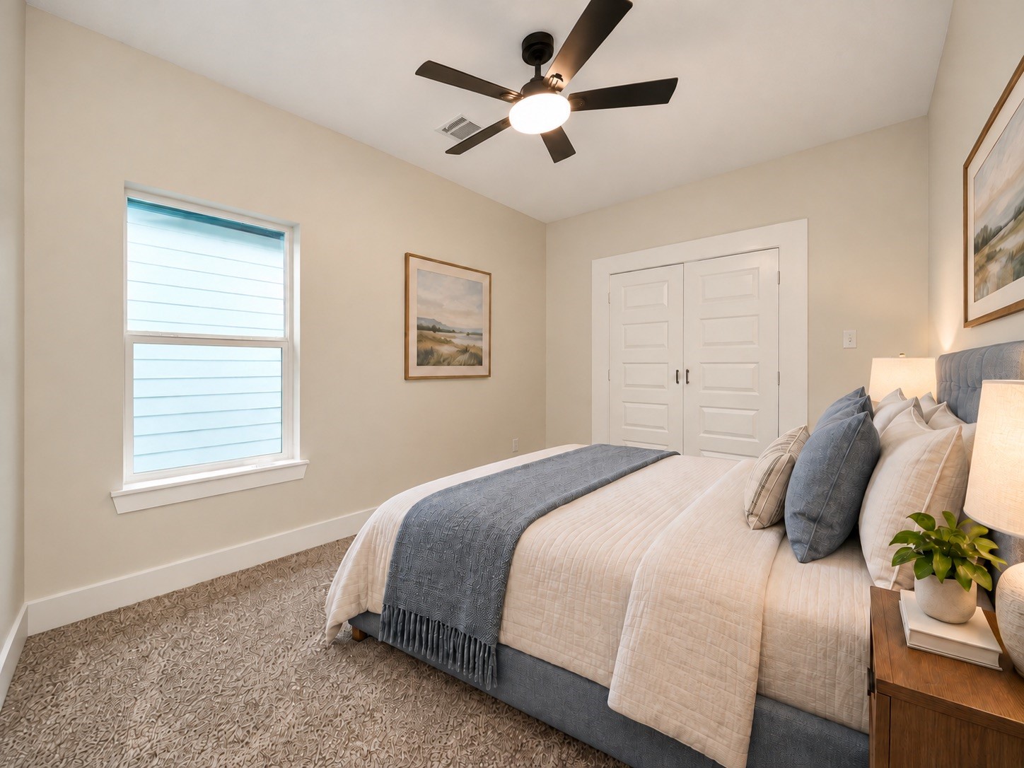 This second-floor secondary bedroom measures approximately 14 x 10 feet and features a ceiling fan, natural light, and a neutral color palette. The room is conveniently located near the shared bathroom. | Virtually Staged