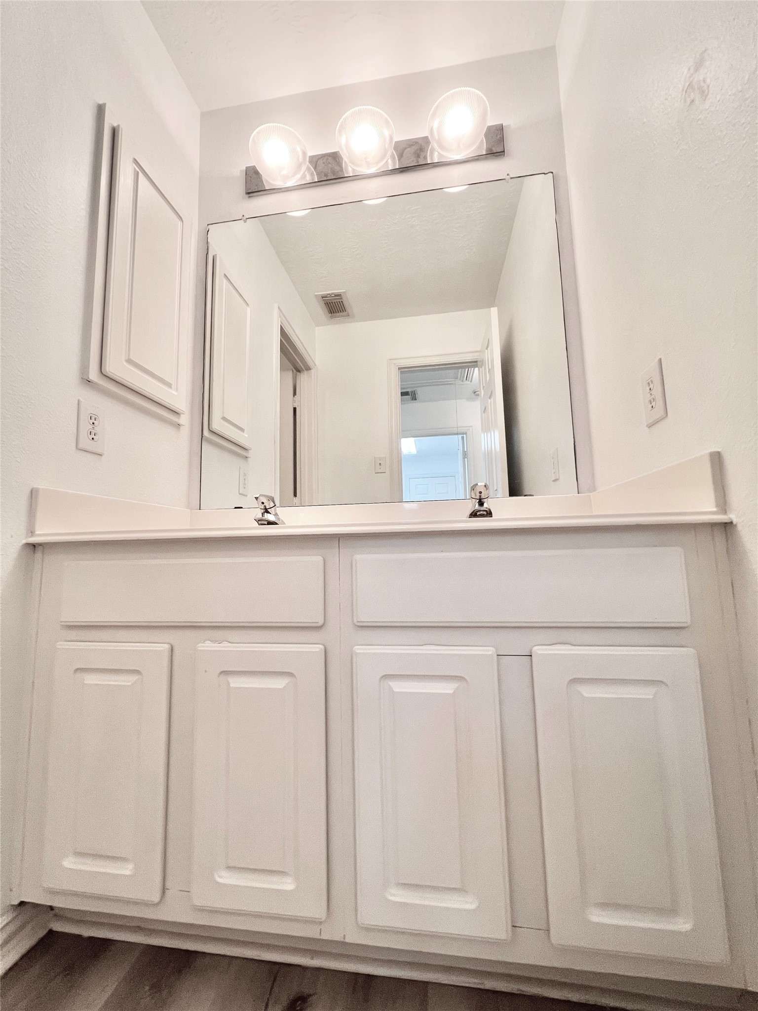 2ndary bathroom vanity area with double sink