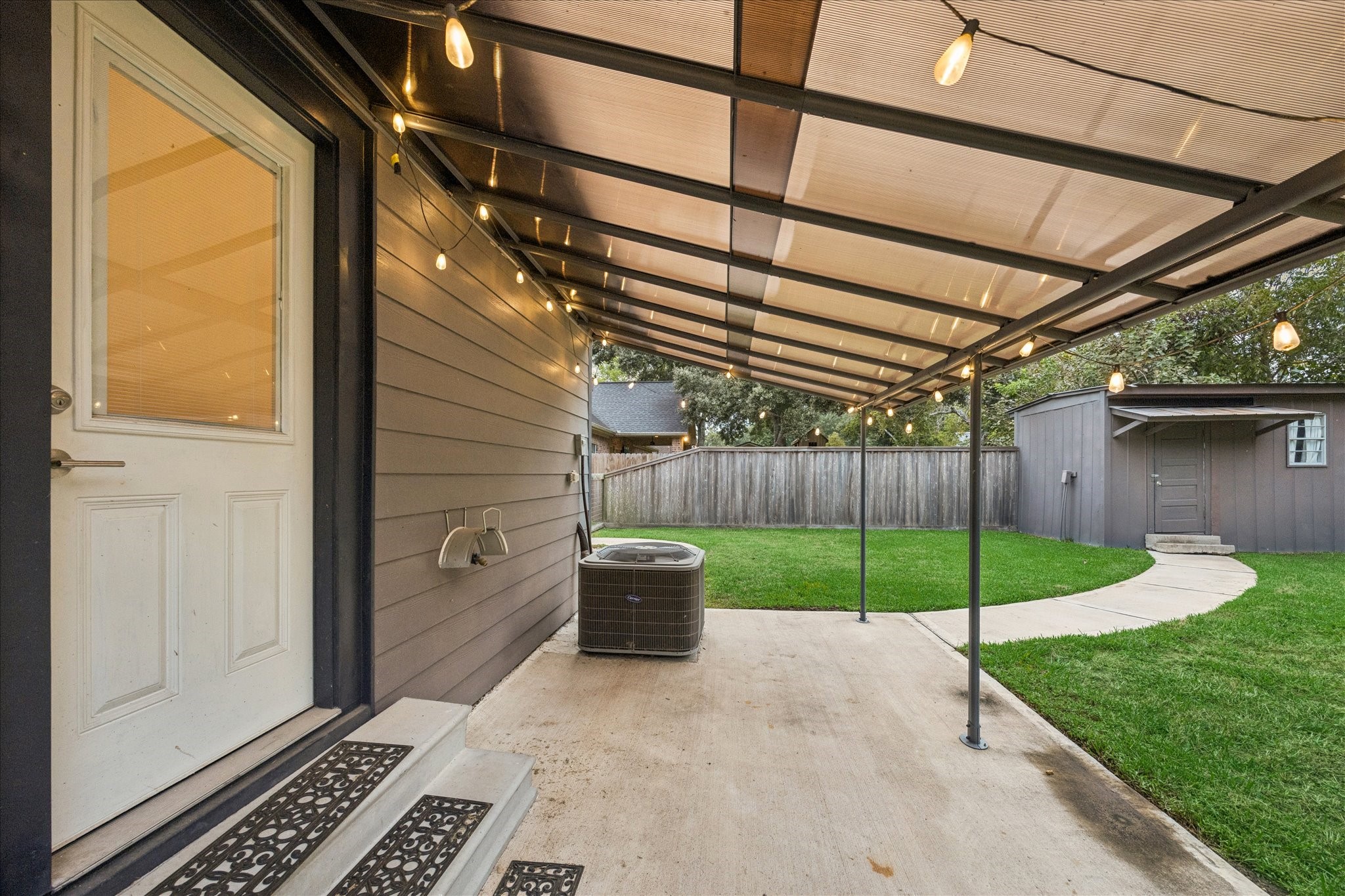 Covered back porch area that the backdoor leads to from the kitchen.
