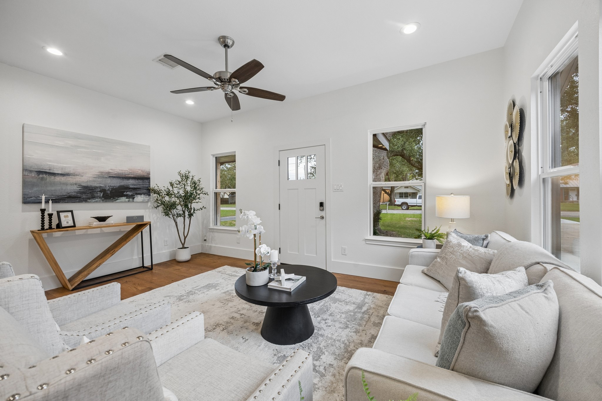 Living room featuring a neutral color palette and abundant natural light from large windows.