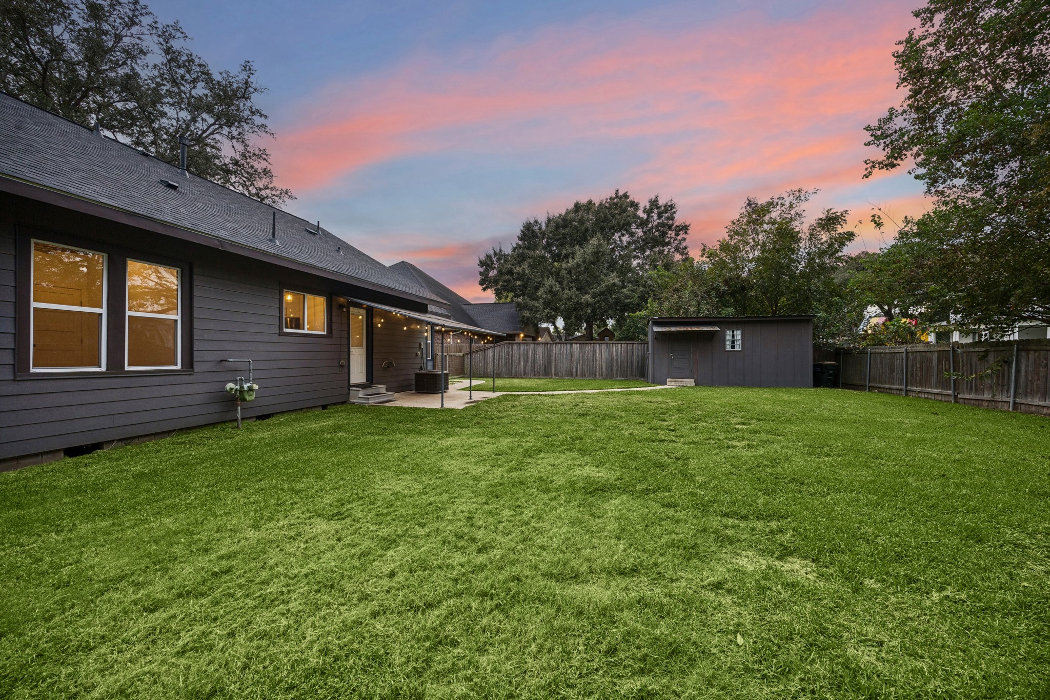 Spacious backyard with a cozy patio, perfect for outdoor relaxation and gatherings.