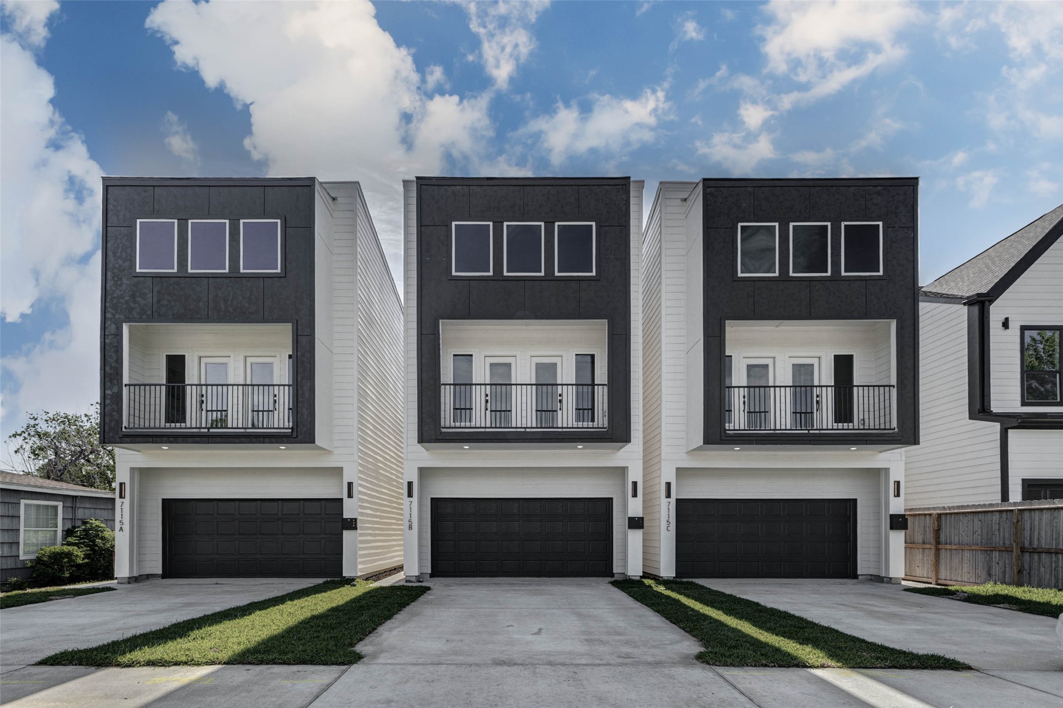 Investment opportunity at 7115B England St  striking new construction with modern faade, private 2-car garage, second-story balcony, and standout curb appeal