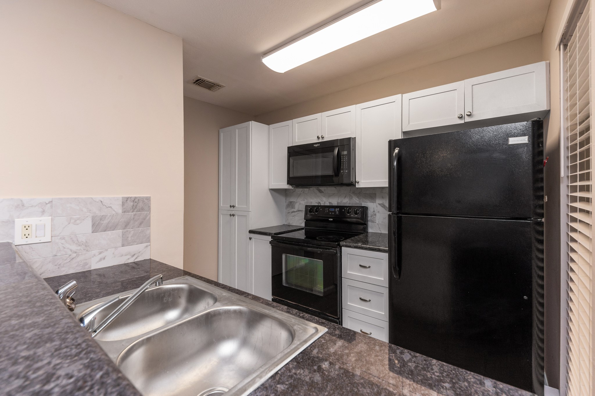This light and bright kitchen offers plenty of storage space.