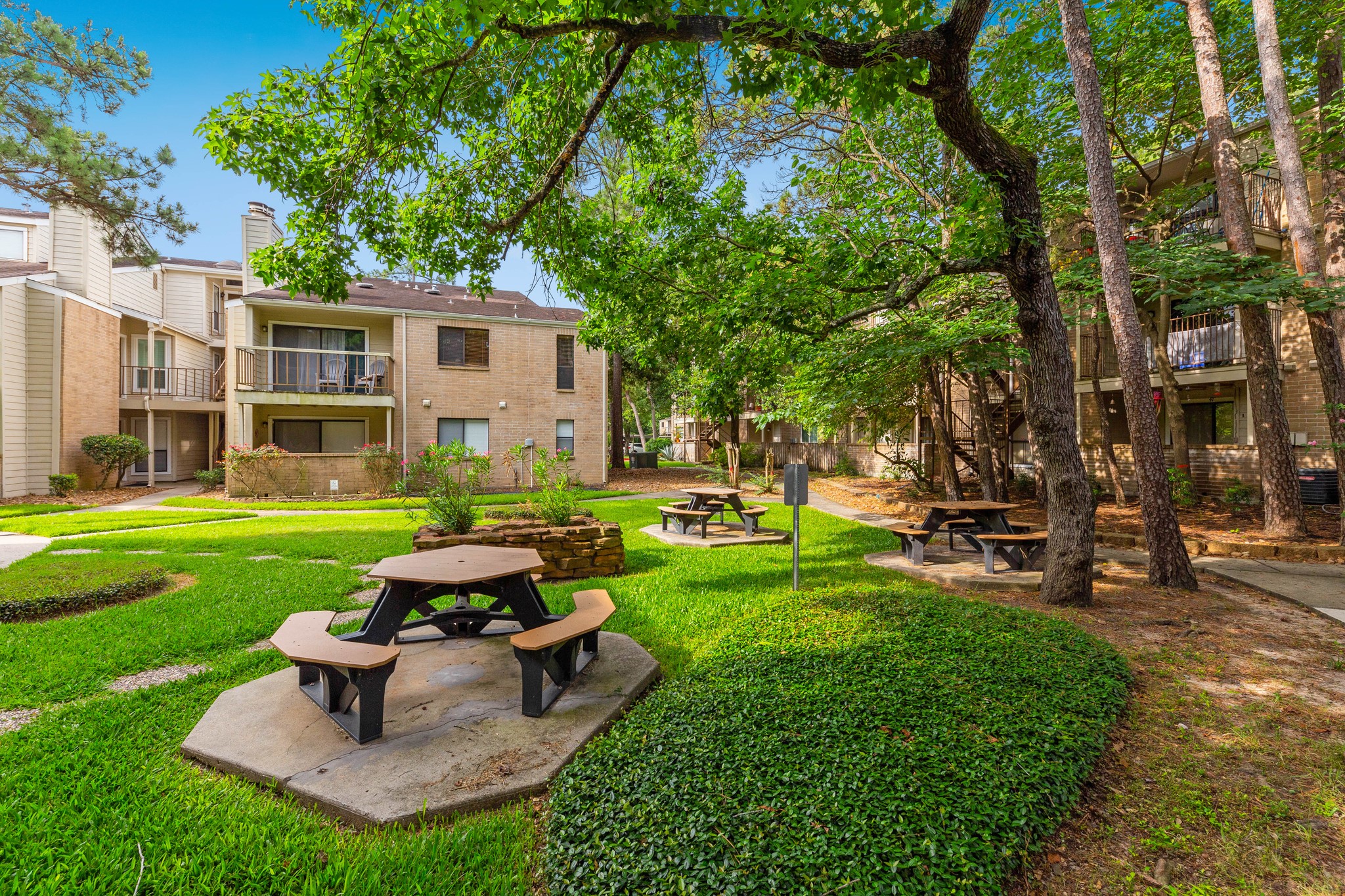 The back patio offers a beautiful view of the common green areas.
