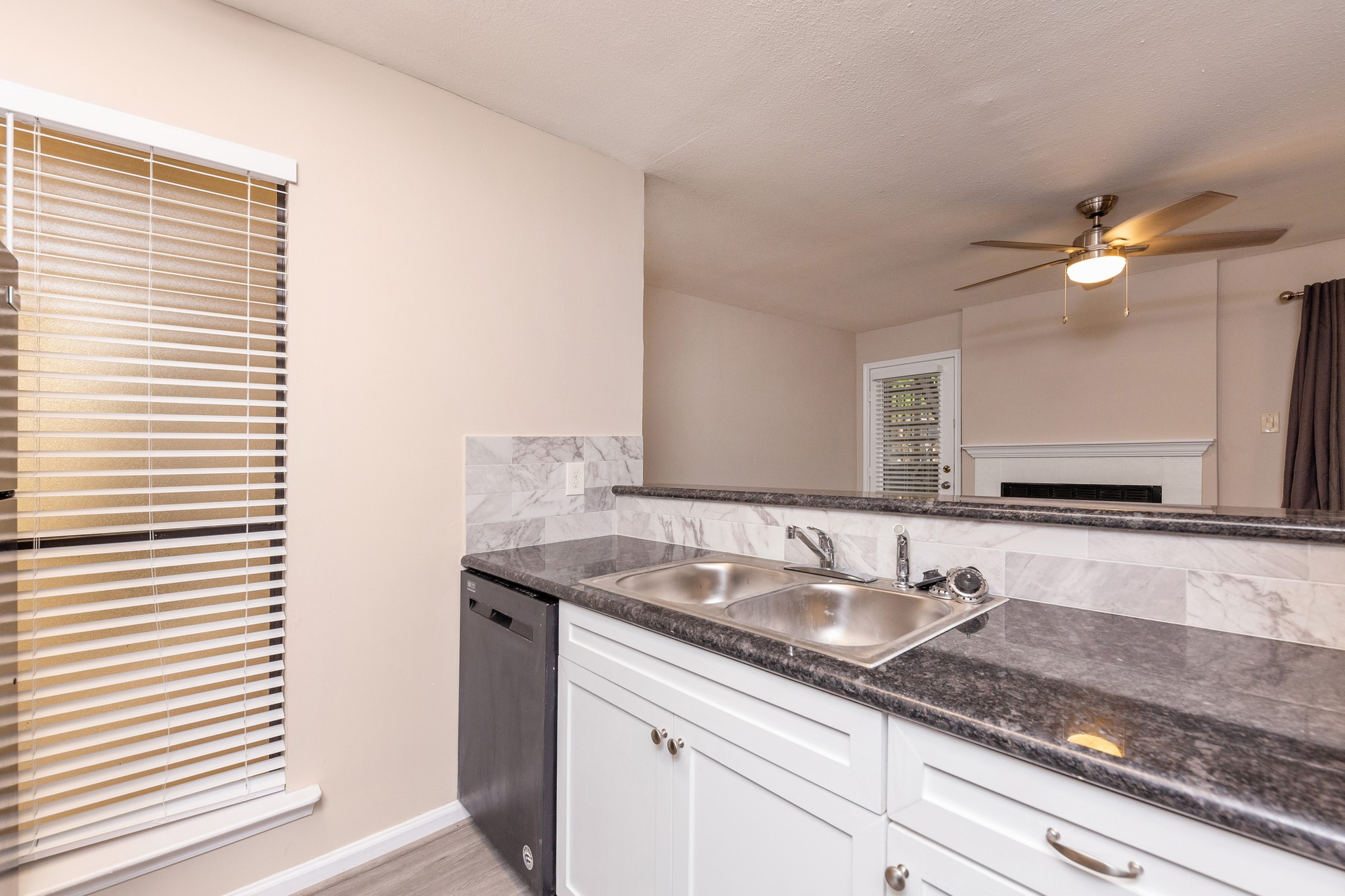 Looking out from the kitchen into the family room, this space is ideal for hosting guests. Looking out from the kitchen into the family room, this space is ideal for hosting guests.
