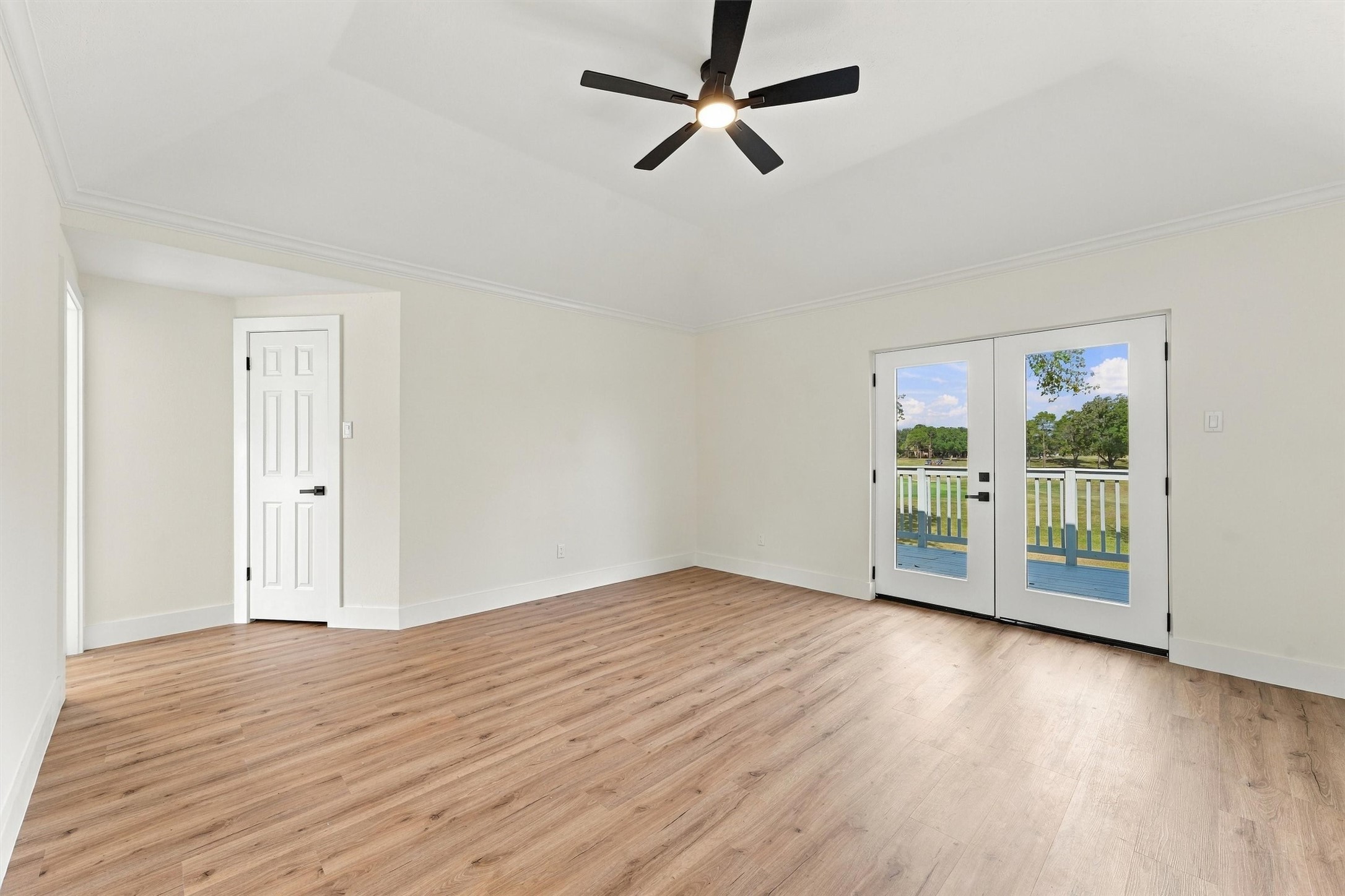 Primary bedroom with access to exterior deck.