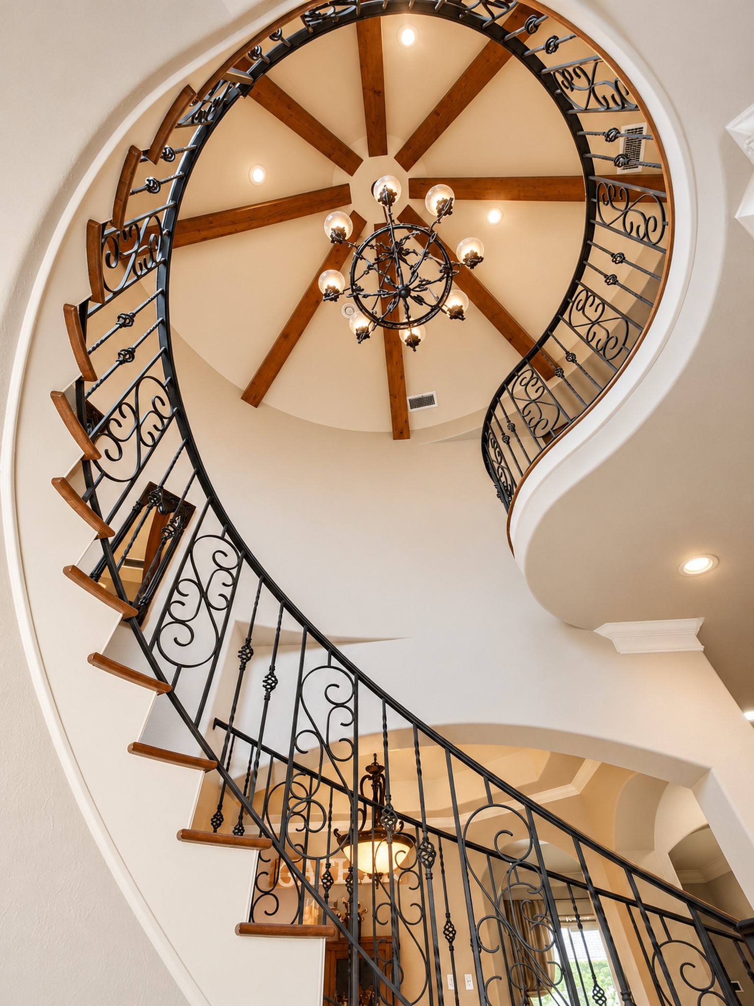 Look up at the turret ceiling with wood beams in the foyer