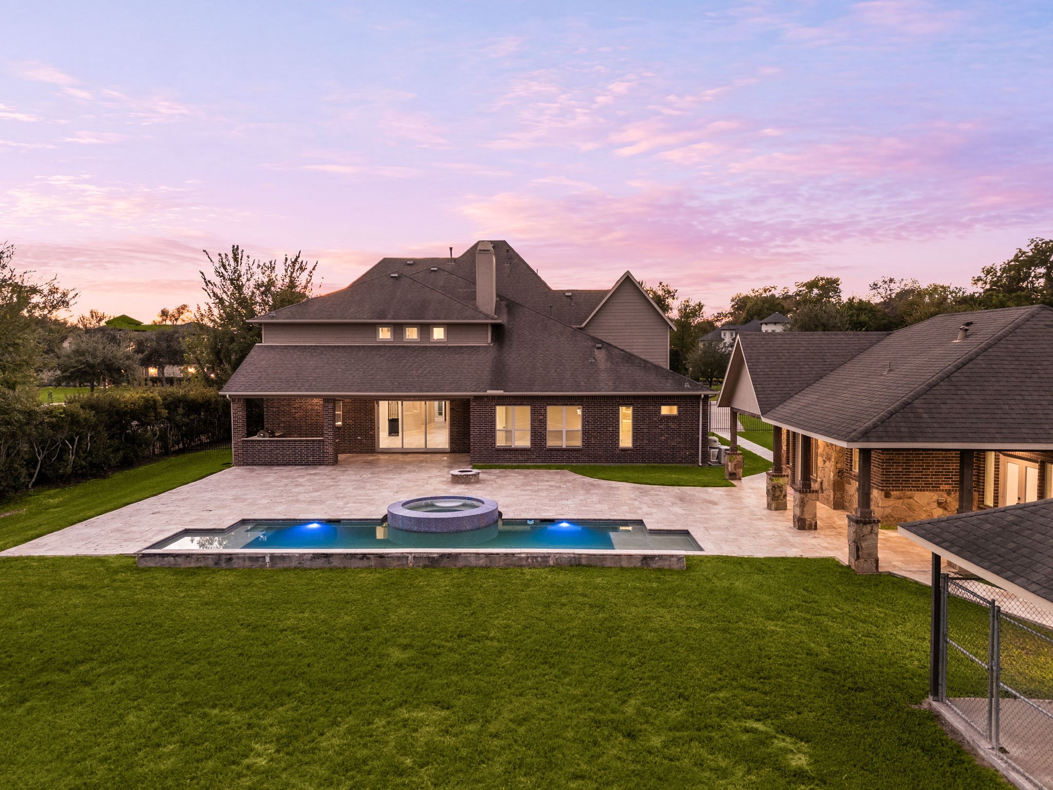 As the sun sets, the backyard oasis comes to life with an in-ground pool, spa, and expansive covered patio, with the detached casita just steps away.