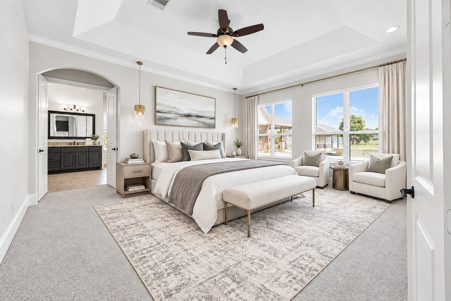 The primary retreat is framed by a dramatic tray ceiling and oversized windows overlooking the private grounds, offering direct access to the spa-inspired ensuite. Virtually staged.