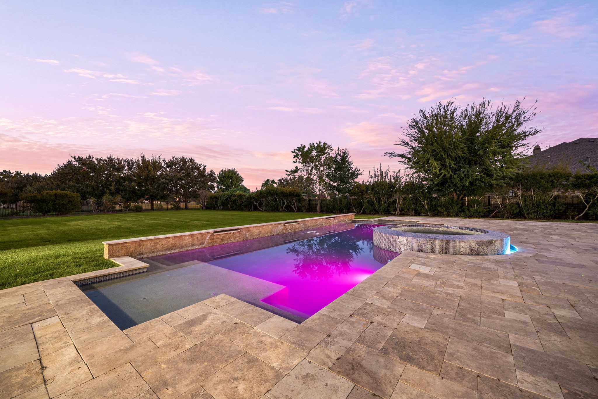 Customizable pool lighting sets the mood for any occasion, adding a dramatic, resort-caliber touch to evenings spent outdoors.