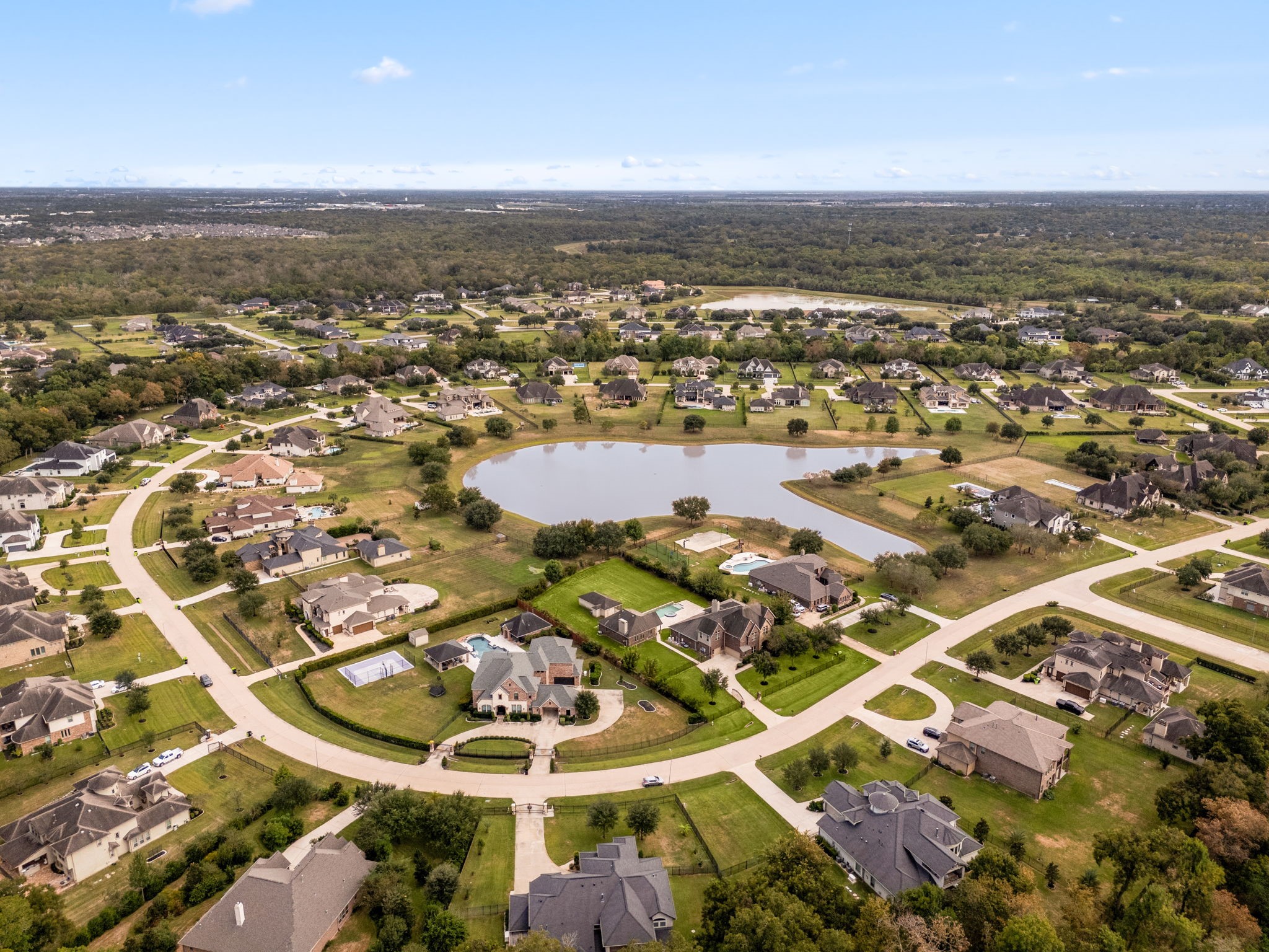 This aerial view showcases the sheer scale of the property and its private, acre-plus lot, set within the established Manors at Silver Ridge community. This aerial view showcases the sheer scale of the property and its private, acre-plus lot, set within the established Manors at Silver Ridge community.