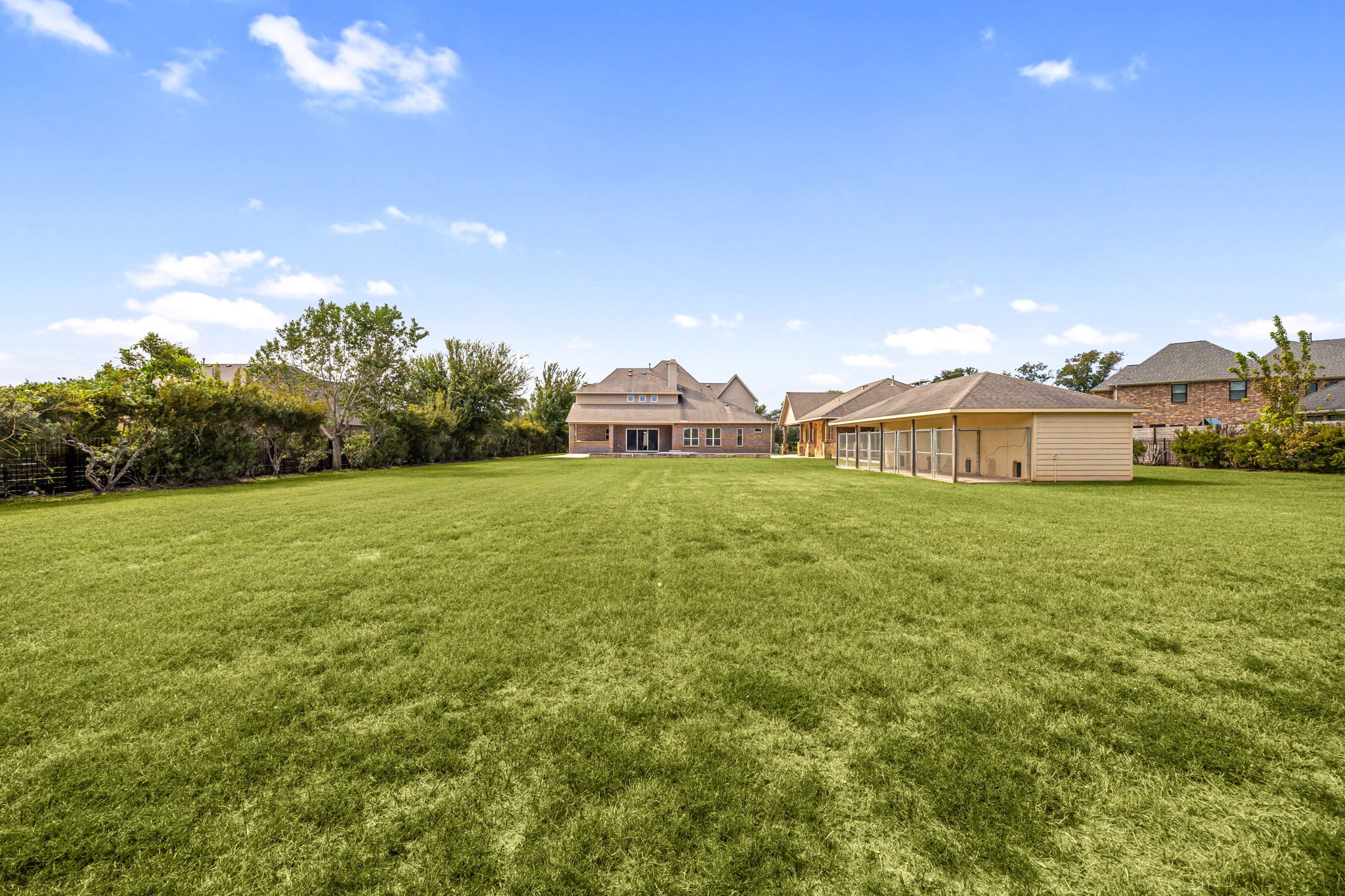 A sweeping lawn stretches across the private, acre-plus lot, offering endless possibilities for outdoor recreation and entertaining.