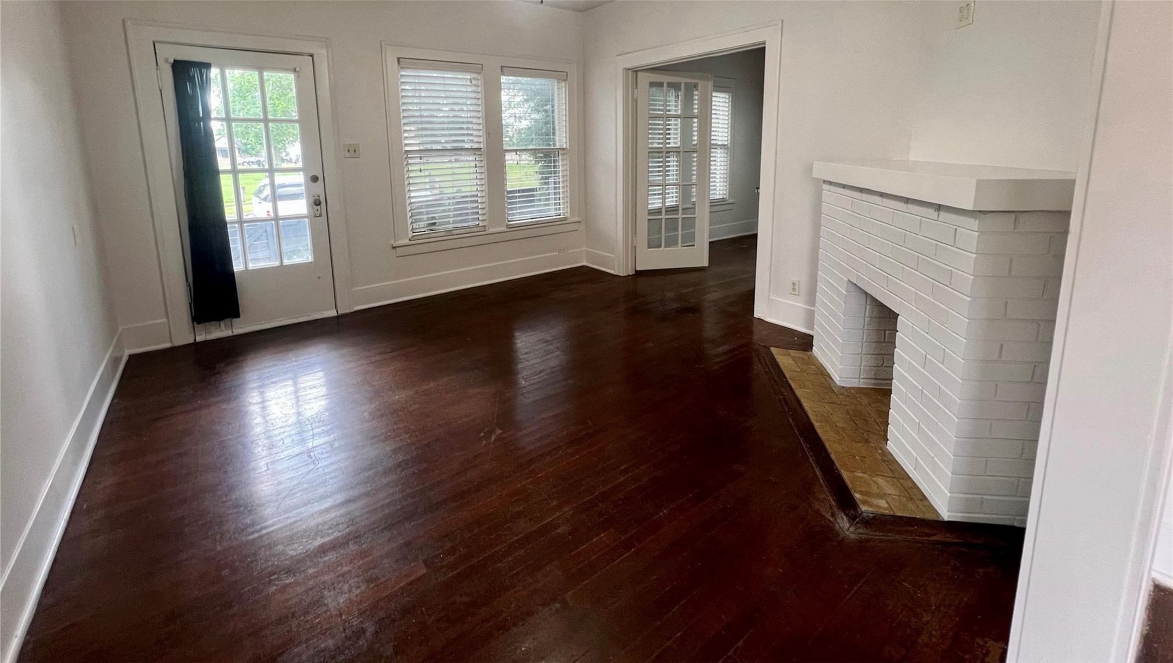 The living area is spacious and features plenty of natural lighting. This downstairs unit opens onto the front deck.