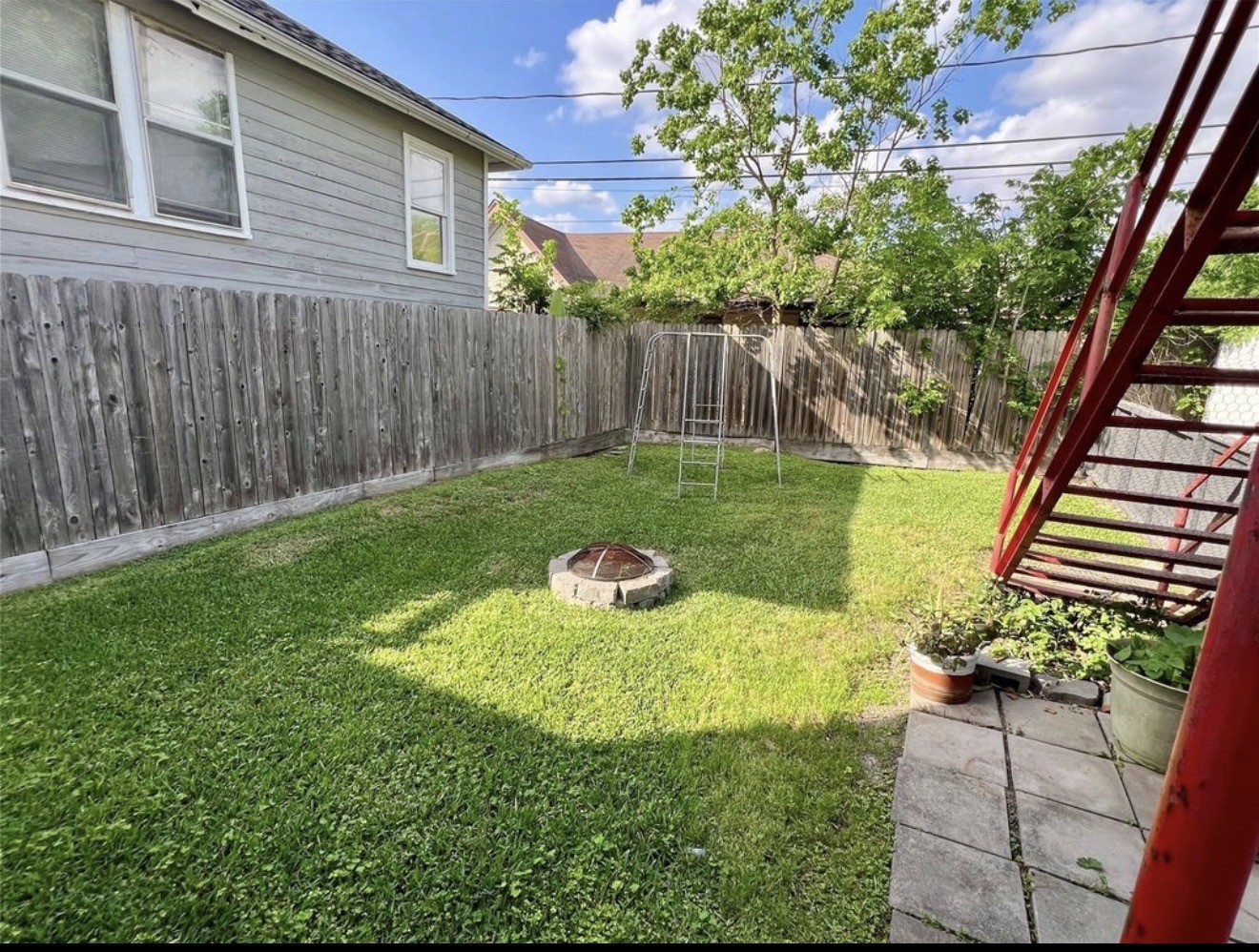 The spacious backyard is fully fenced with plenty of room for activities.