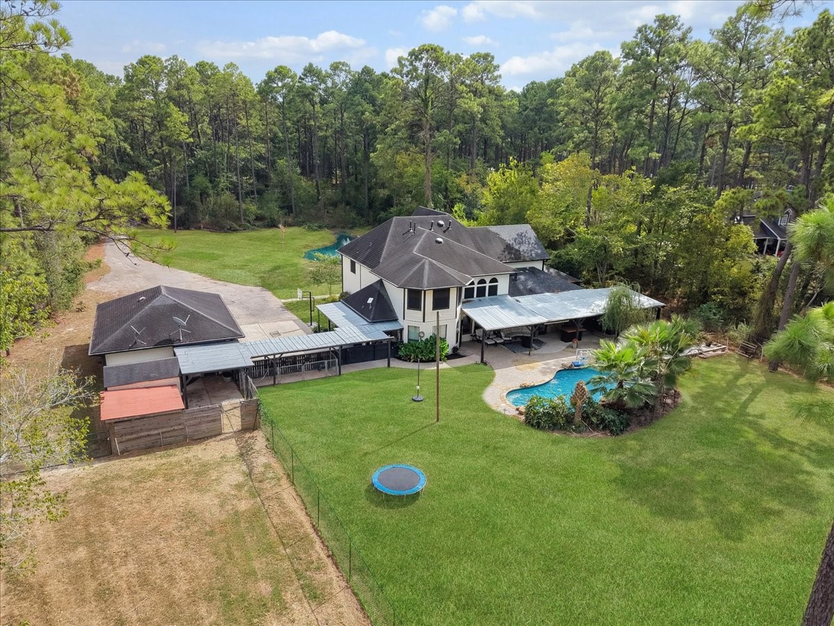 Discover a spacious home nestled in a lush, wooded setting, featuring a large backyard with a sparkling pool and ample patio space, perfect for outdoor entertaining and relaxation. Also, a private airconditioned doghouse with running water.