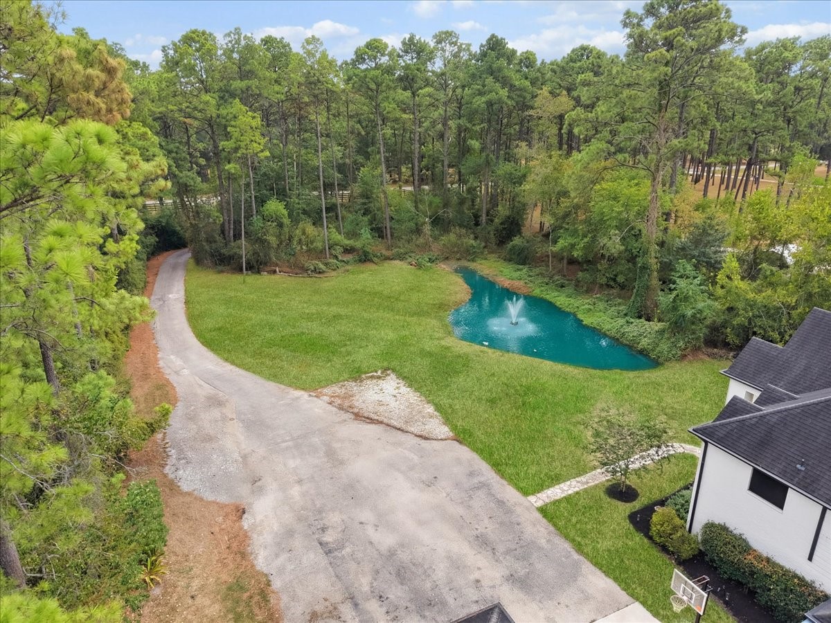 Enjoy your private gated entrance to this wooded 5 acres, and private stocked pond.