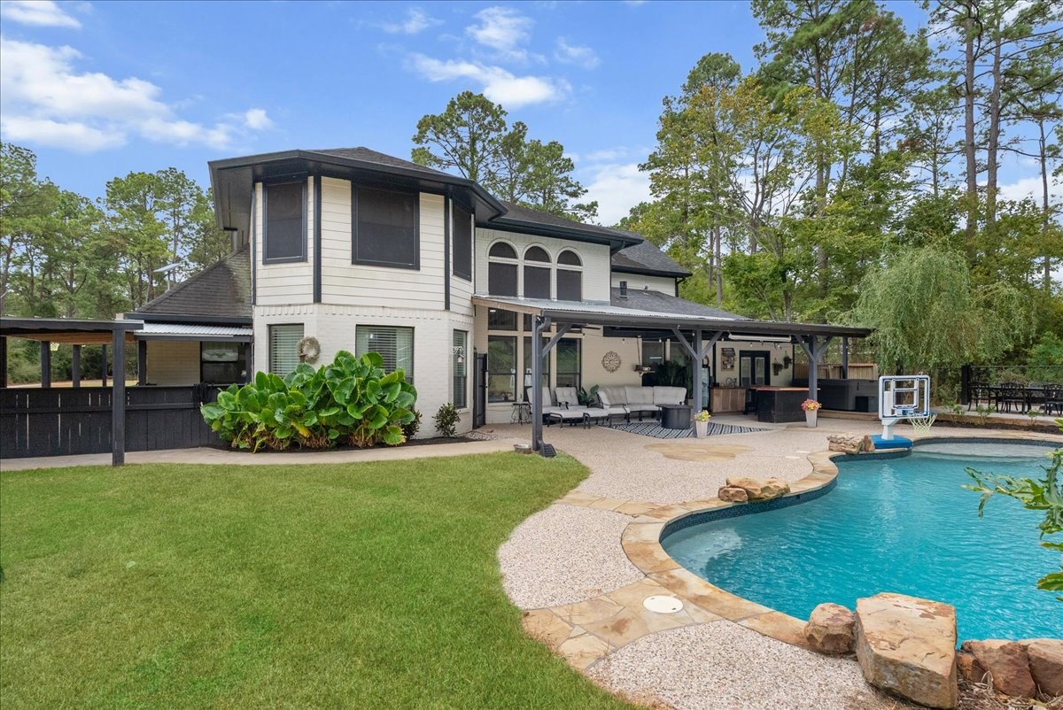 The back of this stunning two-story showcases a sparkling pool and lush landscaping, making it an ideal place for relaxing or entertaining.