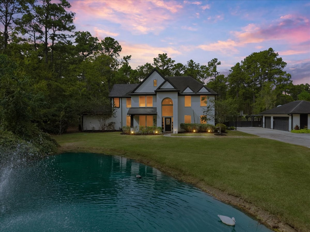 Sunset in the country, Front Elevation facing south in this secluded 5-acre tract, stocked pond, approximately 10' deep, backdrop of elegant two-story