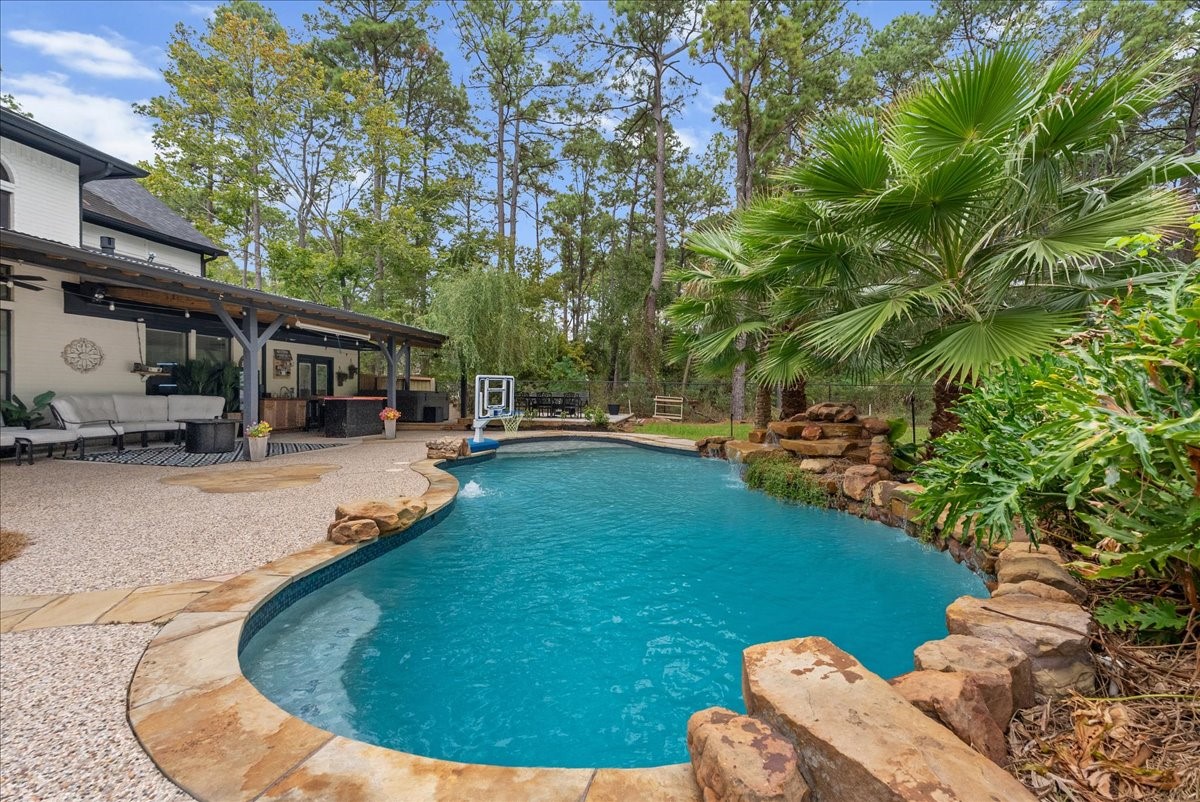 A recently replastered pool and new coping, surrounded by tropical palms and lush landscaping, accentuates paradise.