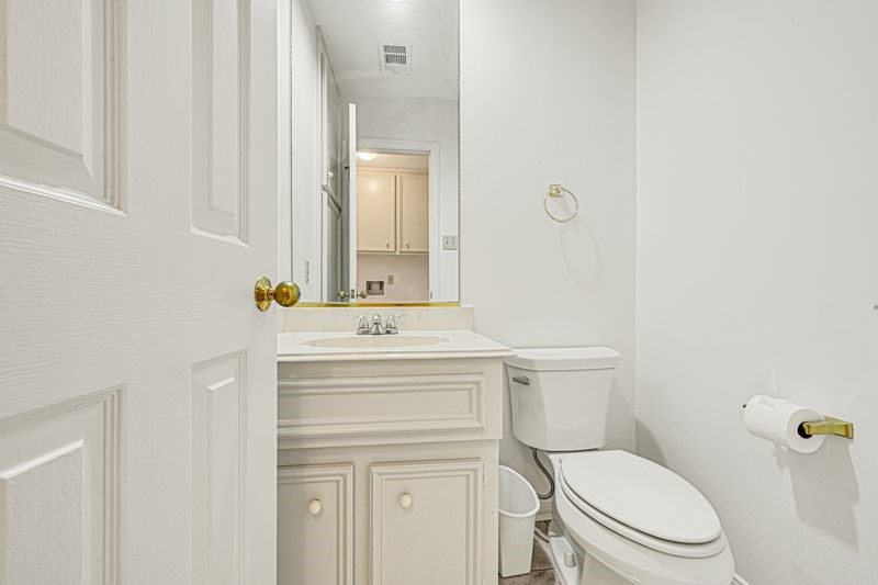 Bright and clean  half bathroom featuring a classic white vanity, modern fixtures, and ample storage.