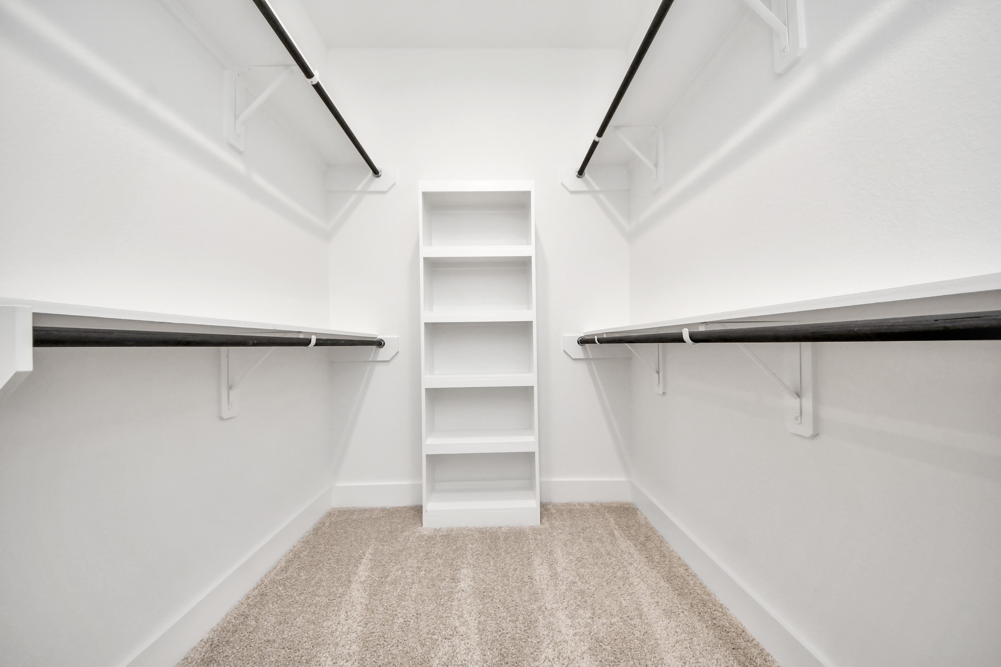 Walk-in closet that epitomizes luxury and practicality. This generously sized space features built-in shelving, offering abundant room for impeccable organization. High ceilings and recessed lighting create a bright and welcoming ambiance.