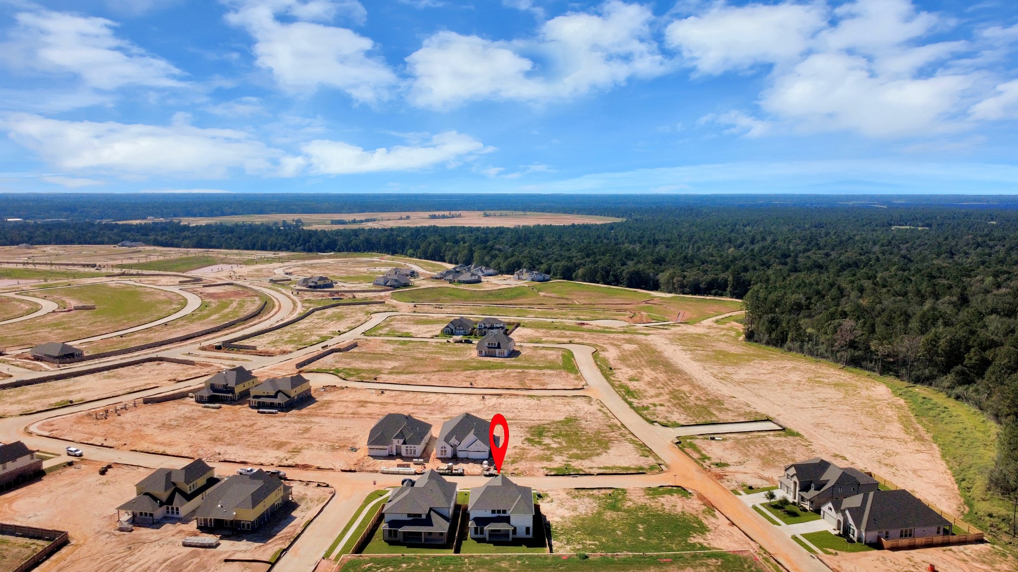 An aerial view of a spacious subdivision lot, highlighting a well-maintained yard and a fully fenced perimeter, offering both privacy and expansive outdoor space.