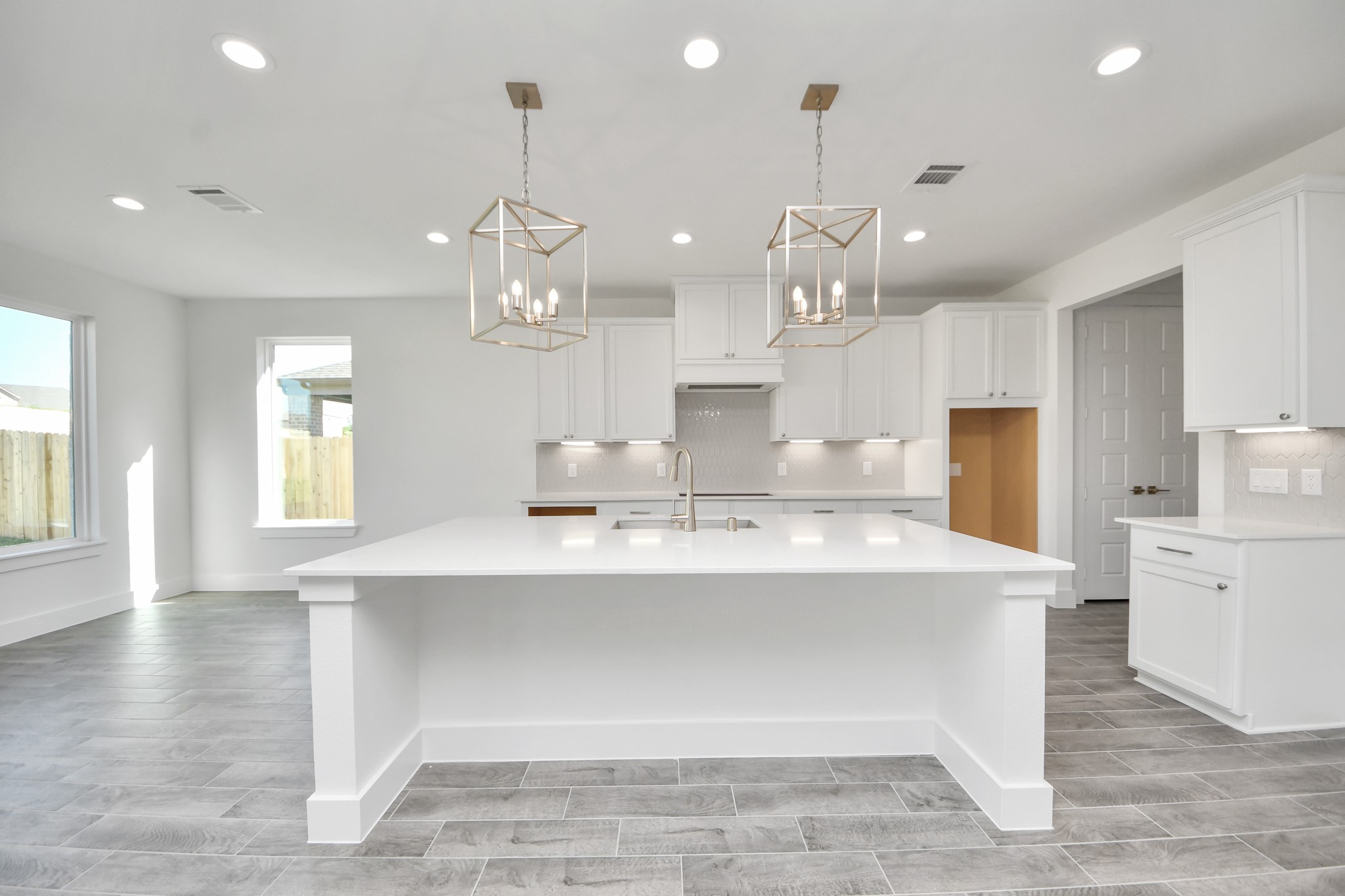This kitchen is by far any chefs dream! This spacious kitchen features high ceilings, stained wood cabinets, granite countertop, SS appliances, modern tile backsplash, recessed lighting, extended counter space, granite kitchen island with double sink, and space for breakfast bar, and a walk-in pantry all overlooking your huge family room.