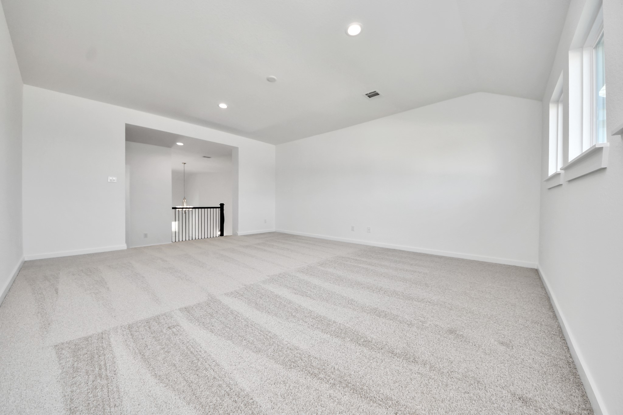 Come upstairs and enjoy a day of leisure in this fabulous game room! This is the perfect hangout spot or adult game room! Features plush carpet, high ceilings, custom paint and windows for plenty of natural light.