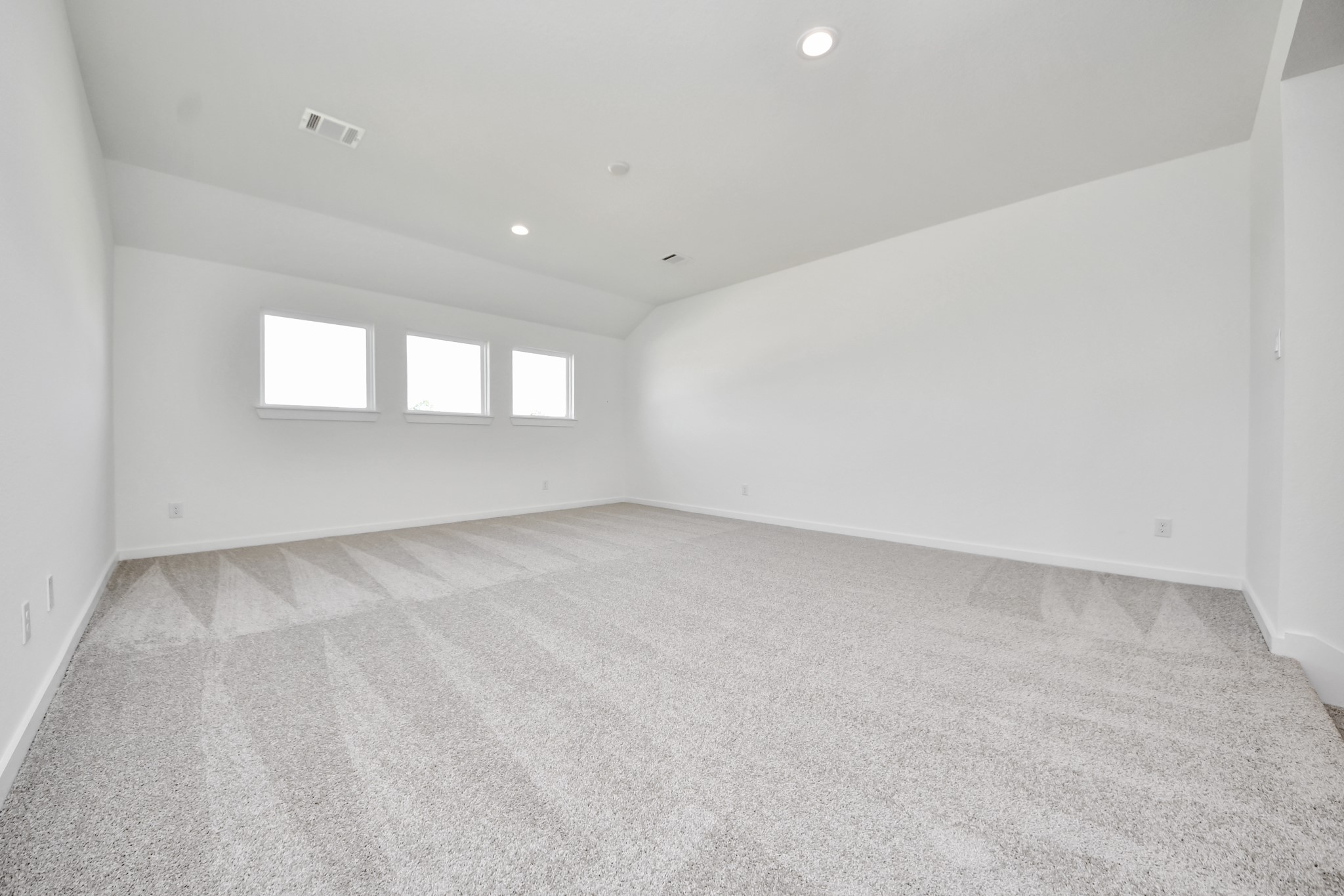 Ascend to relaxation in this fantastic game room! Ideal for both casual gatherings and adult gaming, it boasts plush carpet, lofty ceilings, custom paint, and ample windows for abundant natural light