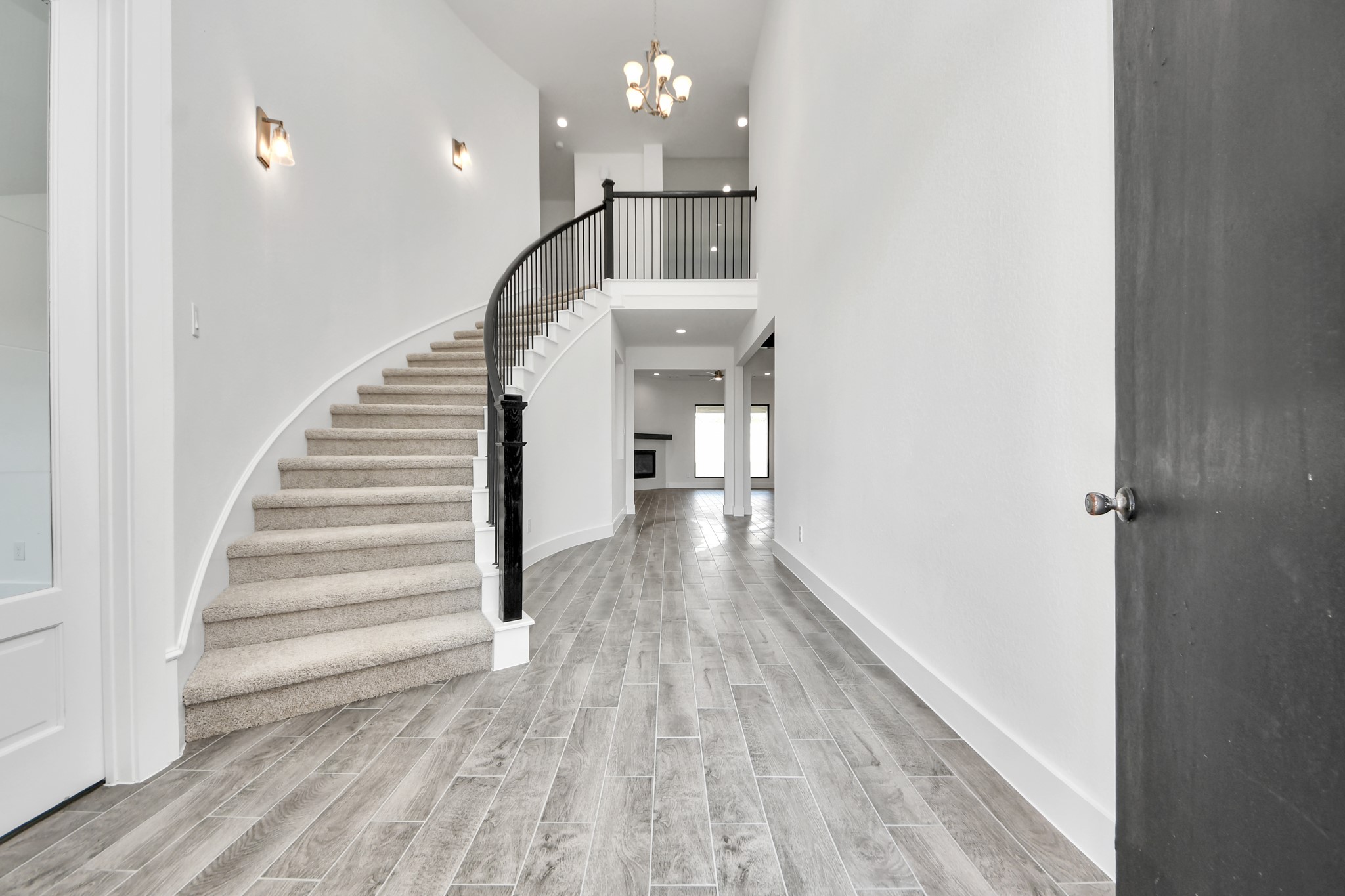 As you step into the threshold of this luxurious home, you'll soon be welcomed by an elegant glass door (to be installed). Inside, soaring ceilings amplify the spaciousness, while the refined wood-look tile flooring and oversized baseboards exude sophistication and charm.