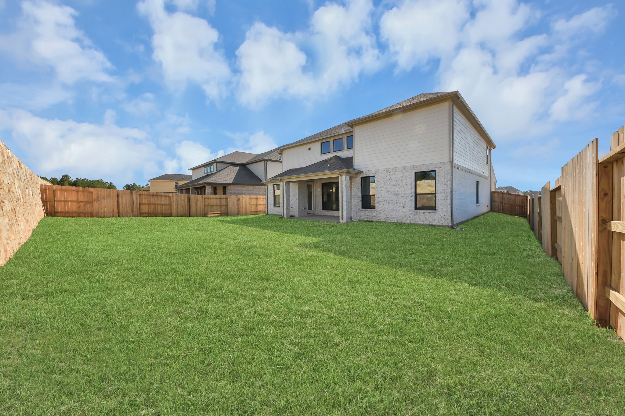 Experience outdoor living at its finest on this expansive covered patio, thoughtfully designed for BBQs and delightful outdoor dining.
