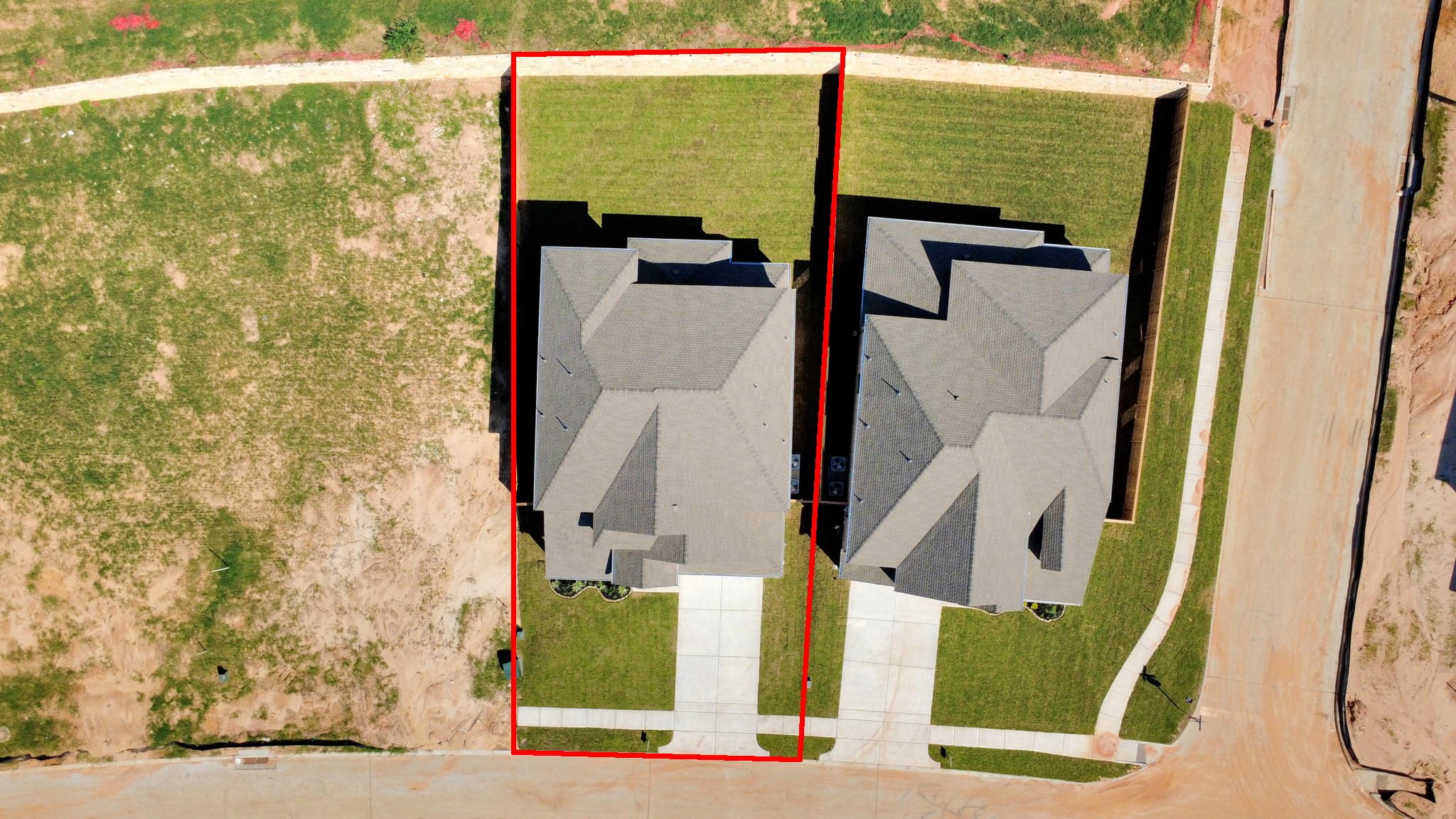 An aerial view of a spacious subdivision lot, highlighting a well-maintained yard and a fully fenced perimeter, offering both privacy and expansive outdoor space.