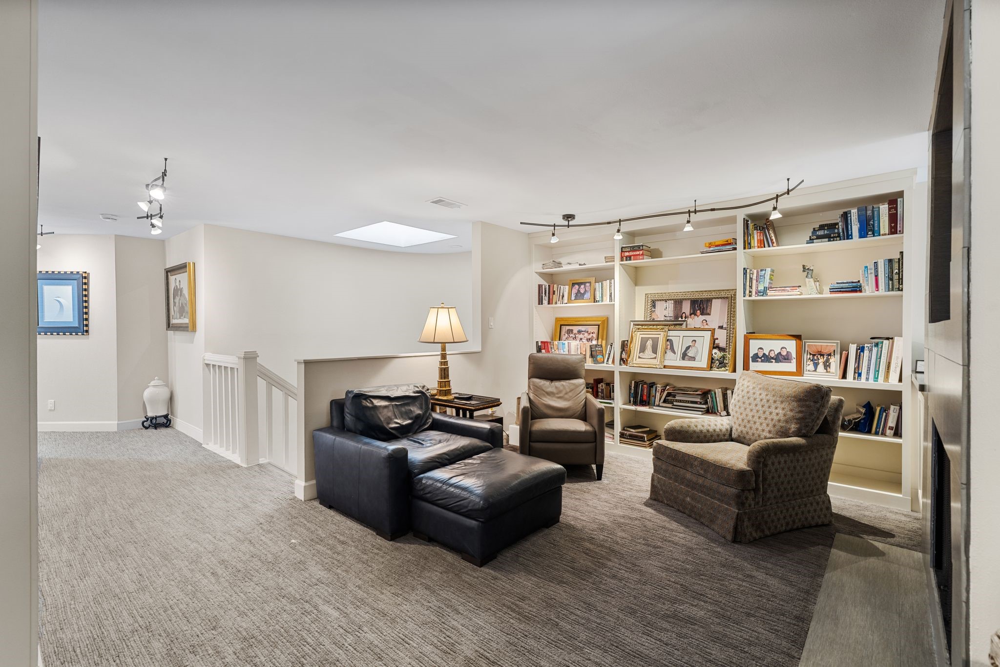 Extensive bookshelves and generous seating space make the upstairs lounge an inviting gathering area, with a skylight bringing in natural light.