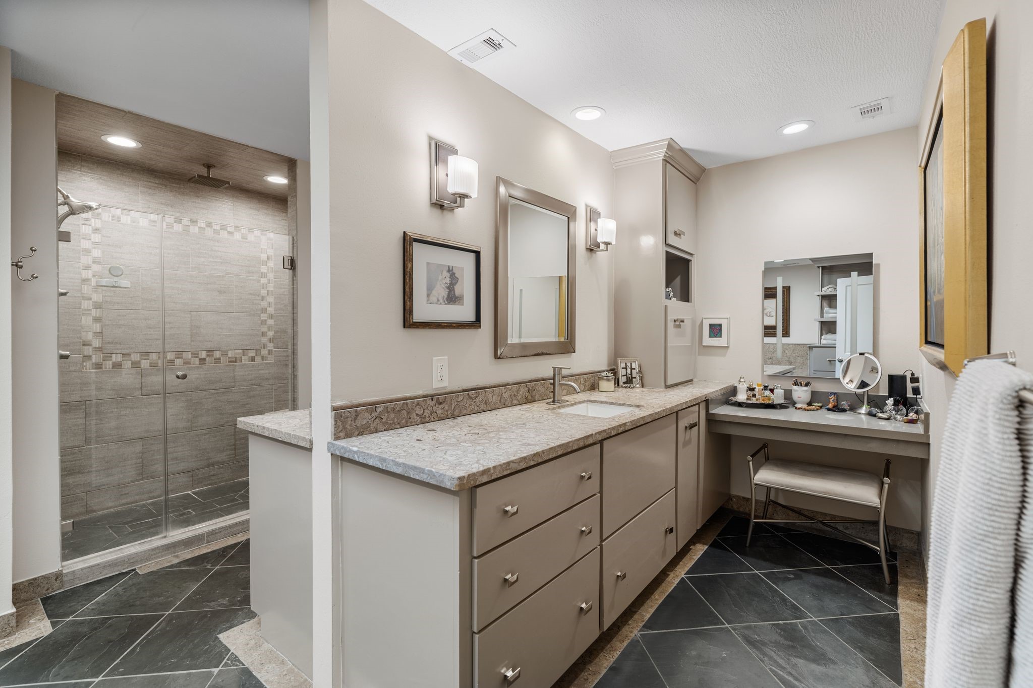 The back to back vanities create a separate space while still in the same area.  The generous drawer storage and a dedicated makeup station bring everyday convenience to the primary bath.