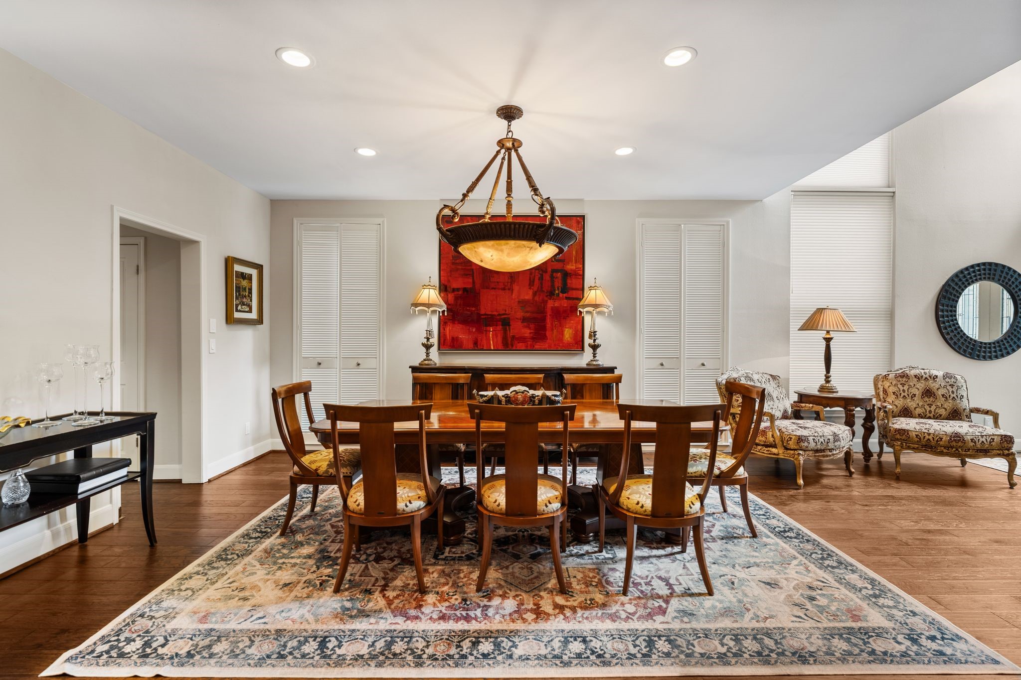 The generous dining area accommodates both a full dining area and an inviting sitting area beside the tall windows.