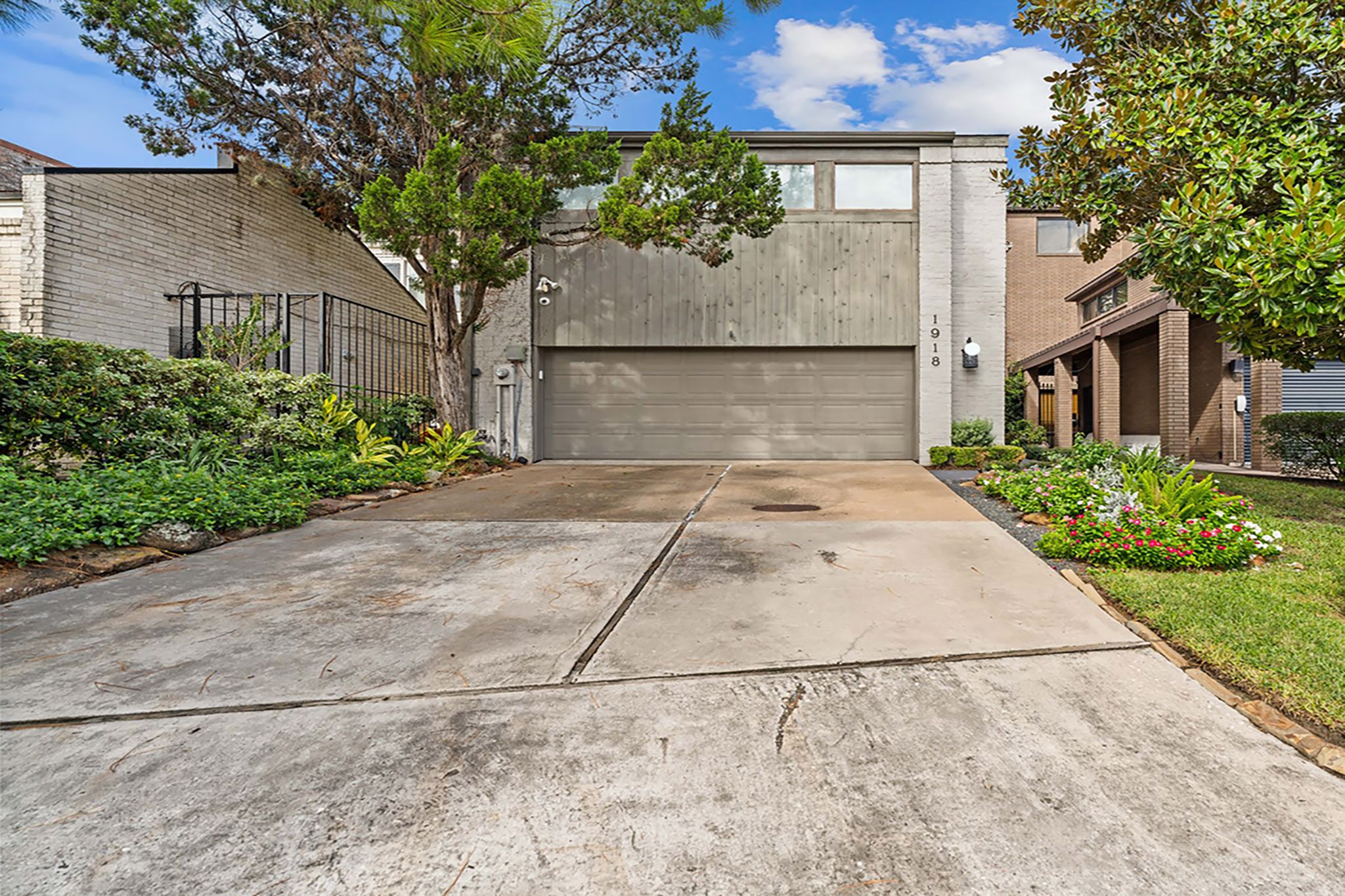 Contemporary architecture, mature landscaping and an attached two-car garage welcome you to 1918 Stoney Brook Drive.