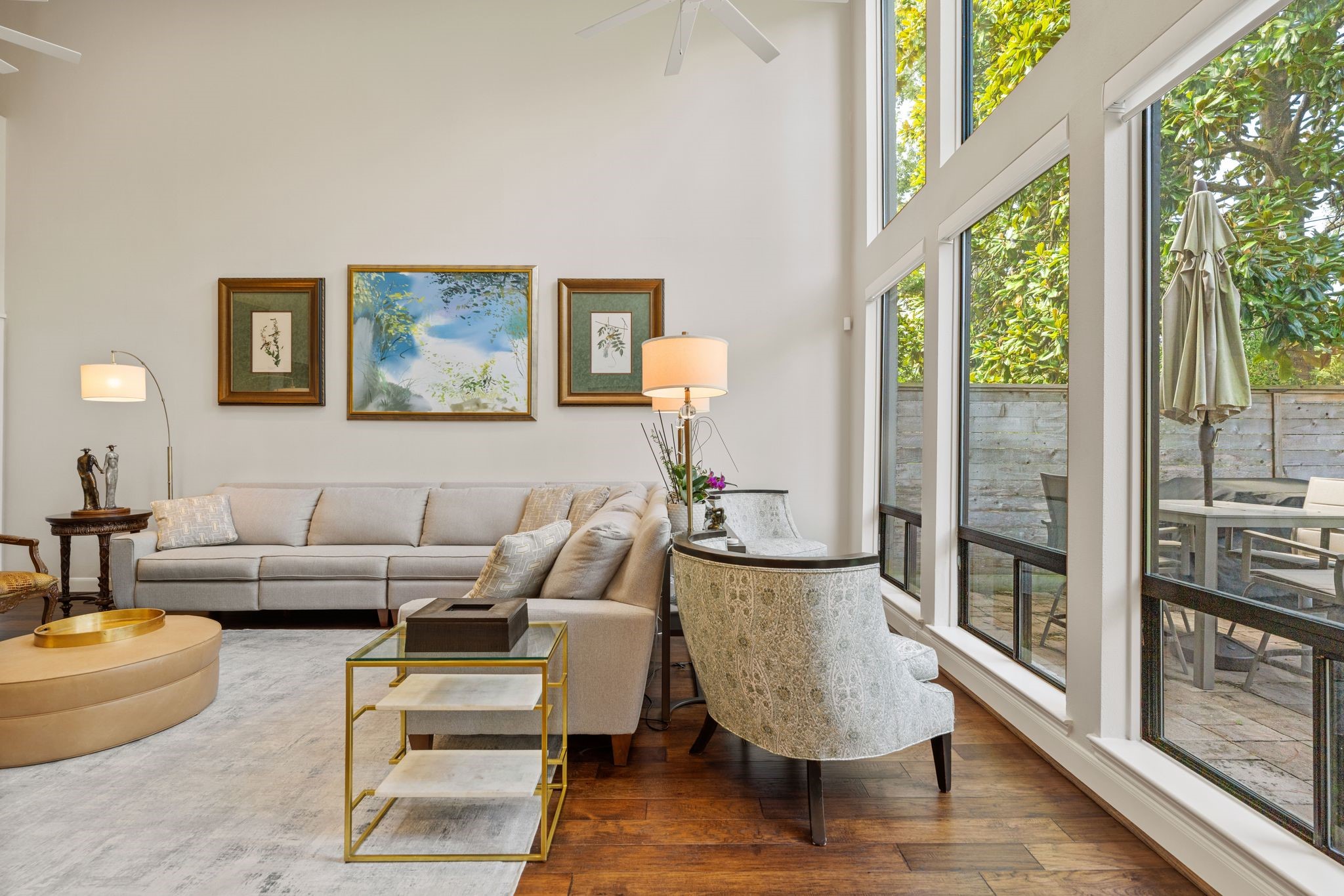 Expansive windows overlook the patio and greenery, creating a bright, comfortable spot for reading, conversation or simply enjoying the view.