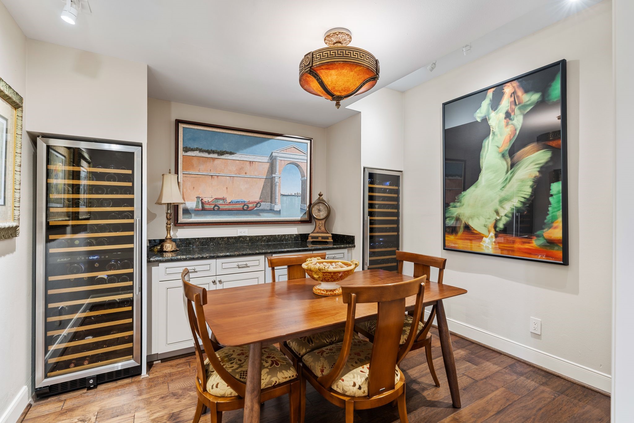 Two tall wine refrigerators, built-in cabinetry and a serving counter create an inviting setting for wine tastings and conversation.