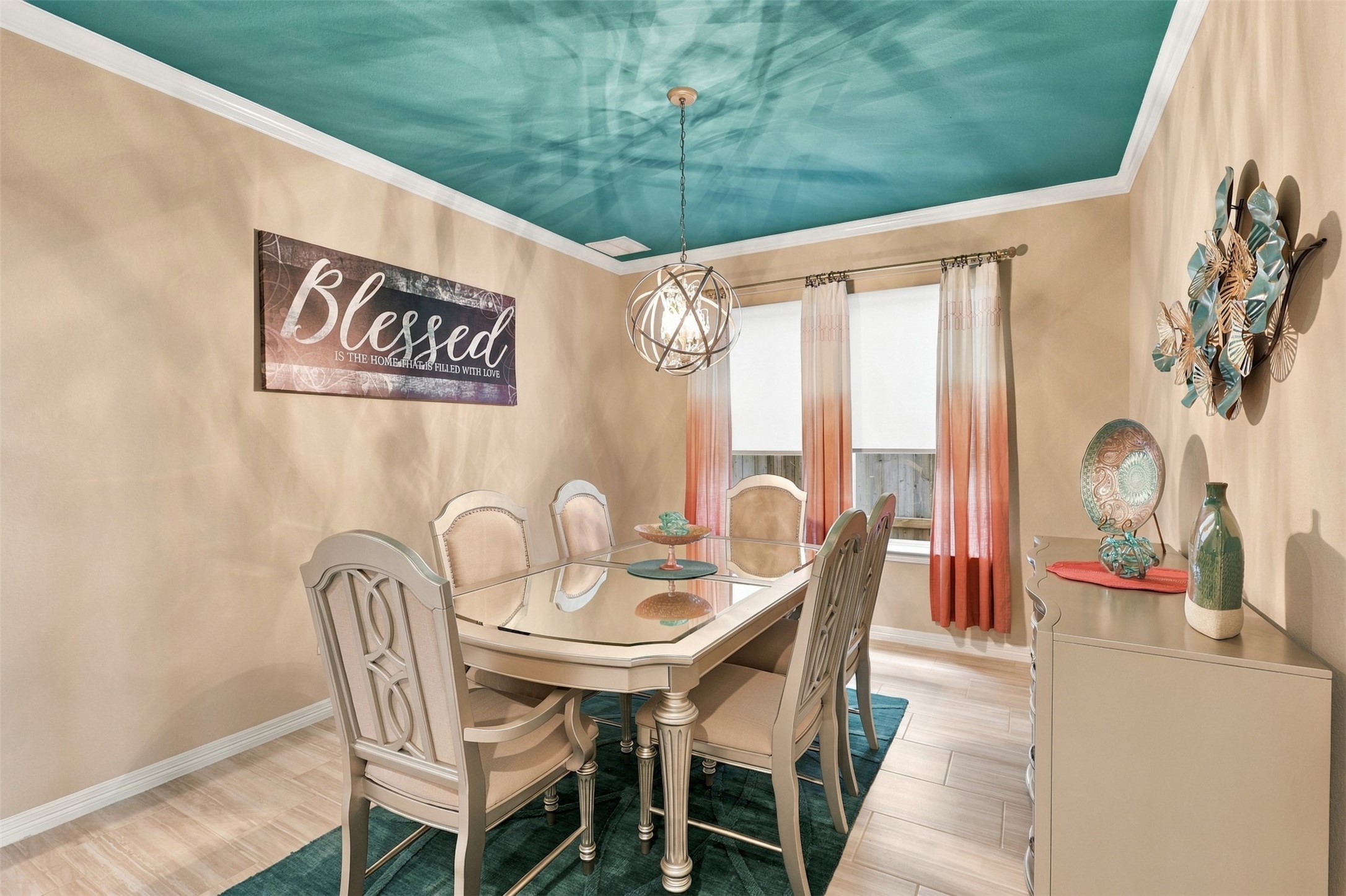 ABSOLUTELY BREATHTAKING! This SHOWSTOPPING formal dining room is a masterpiece of elegance, personality, and designer flair! LOOK UP and admire the spectacular custom teal ceiling that creates an unforgettable WOW FACTOR! A dazzling chandelier adds a touch of glamour, while stylish furnishings complete this picture-perfect setting! Imagine hosting elegant dinner parties, unforgettable holiday celebrations, and cherished family gatherings in this extraordinary space!