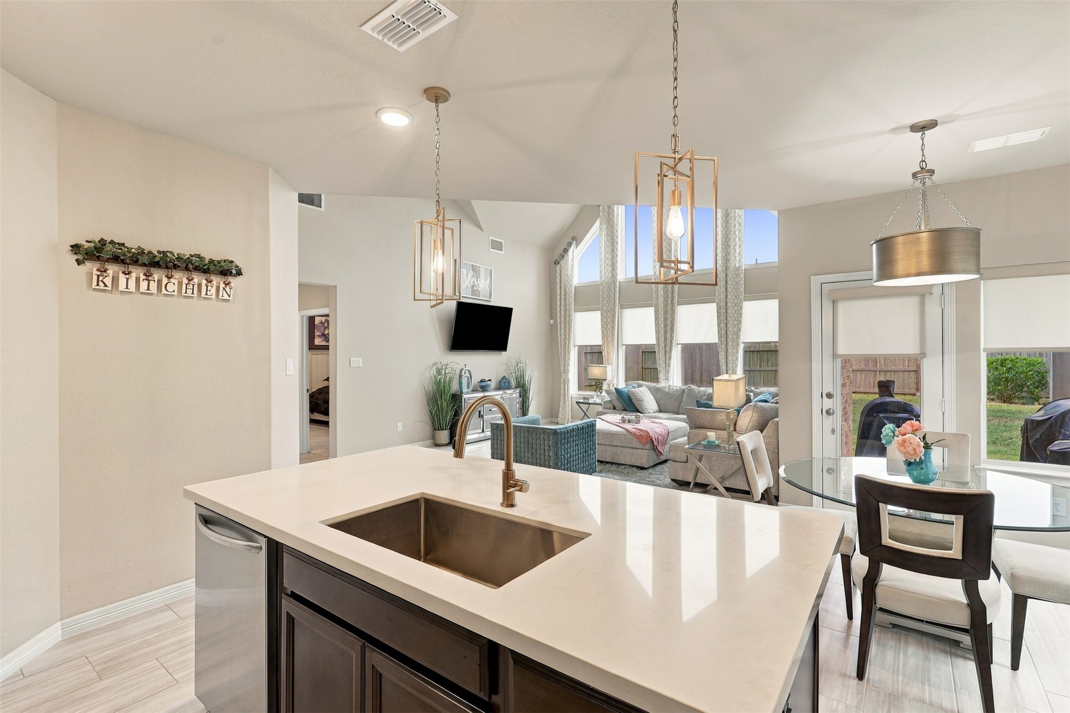 THE HEART OF THE HOME & A TRUE SHOWSTOPPER! Prepare to be AMAZED by this breathtaking gourmet kitchen, where elegance meets extraordinary design! Gorgeous gleaming quartz countertops, a MASSIVE center island with sleek undermount sink, and dazzling designer pendant lighting create an unforgettable WOW FACTOR! But WAIT until you see the VIEW! This spectacular open-concept kitchen overlooks the magnificent family room with its soaring ceilings and dramatic walls of windows!
