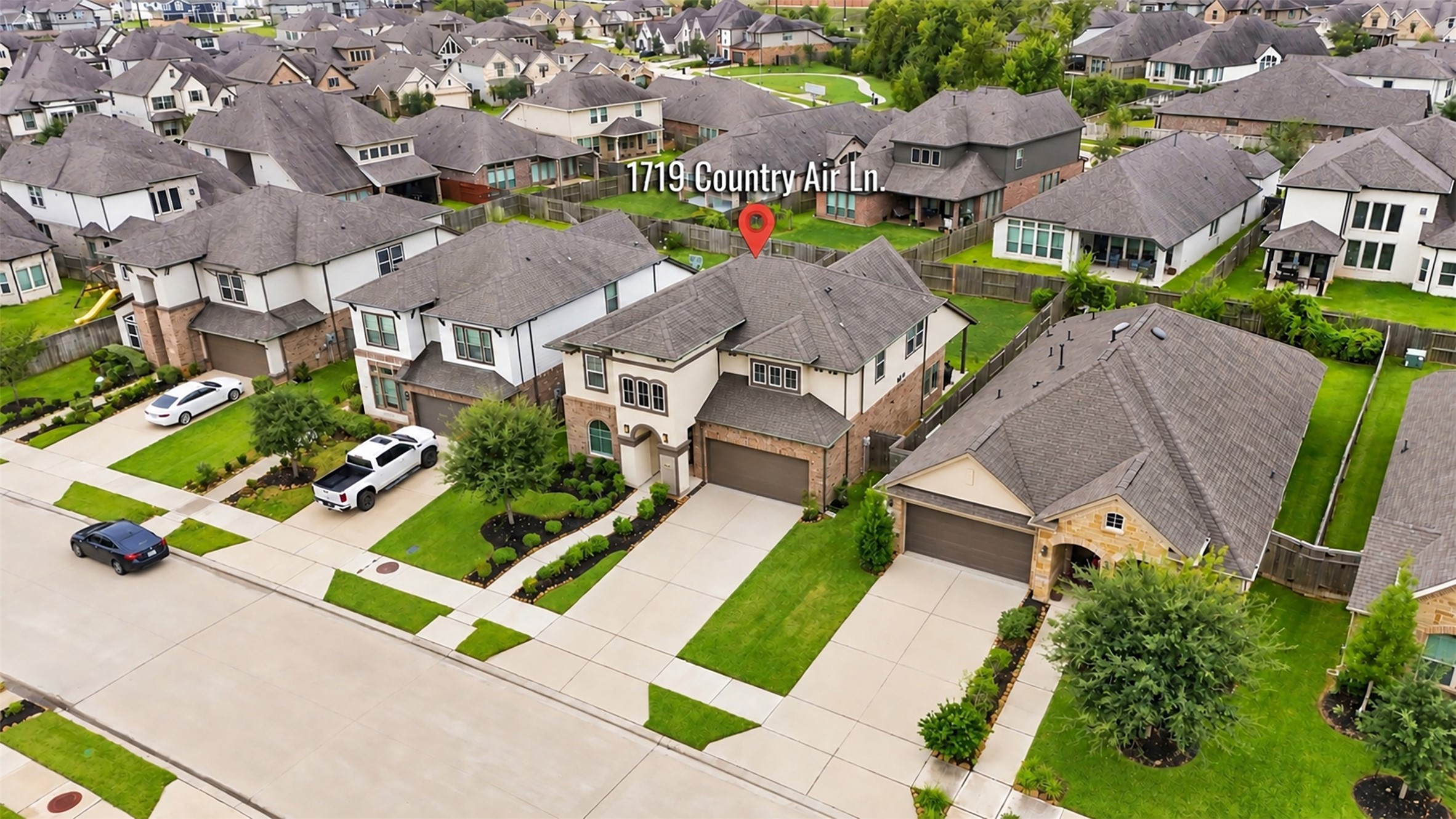 A bird's-eye view of this beautiful home and its welcoming neighborhood! Enjoy a closer look at the attractive homes, well-maintained lawns, and neighborhood streets that create an inviting residential setting.