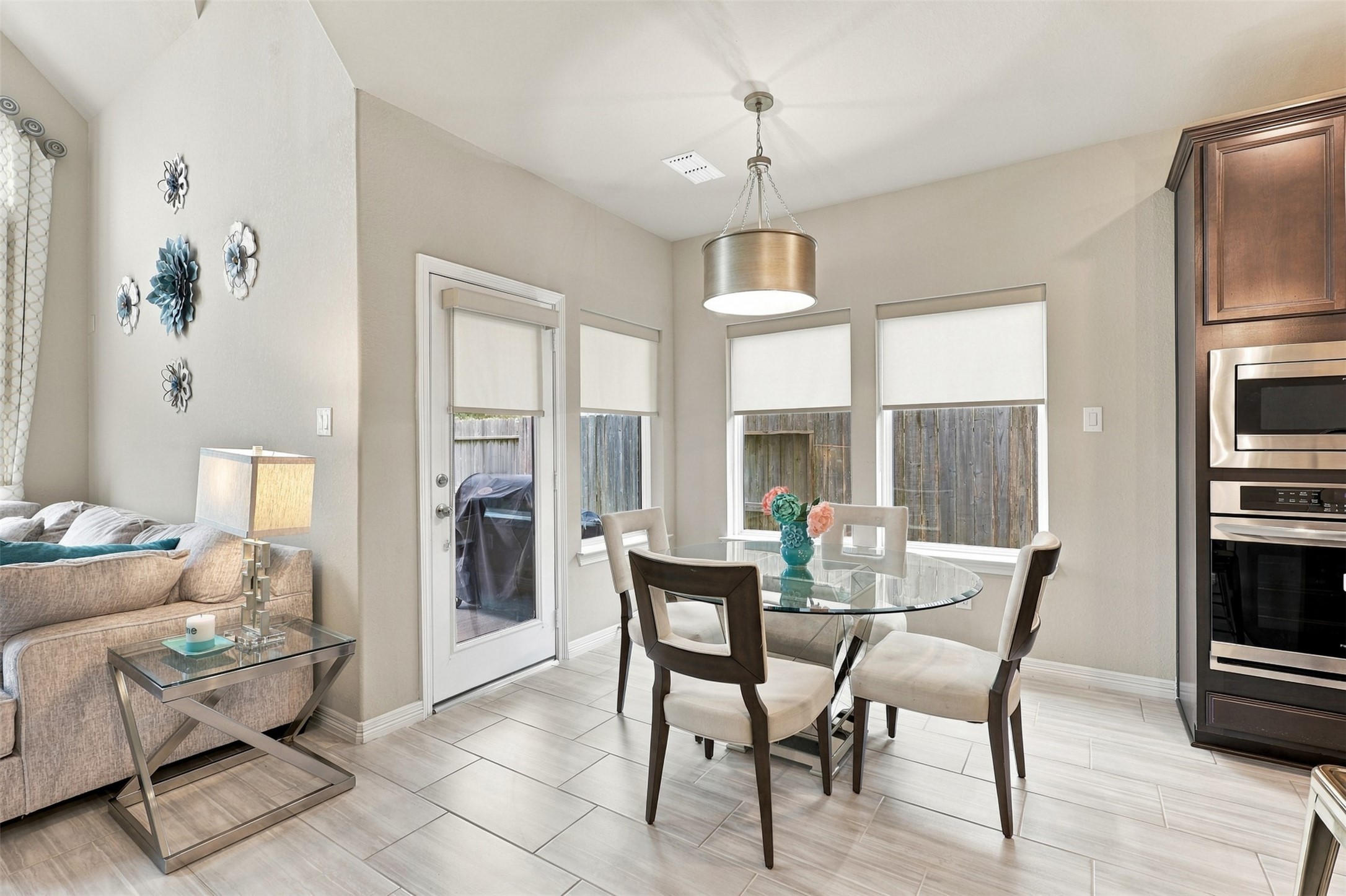GOOD MORNING, SUNSHINE! Imagine starting each beautiful day in this CHARMING casual dining area, where gorgeous windows welcome an abundance of natural light! Elegant custom window treatments and a stylish designer pendant light add that perfect touch of sophistication and warmth! Enjoy your morning coffee, leisurely weekend breakfasts, or intimate dinners with those you love! Perfectly positioned beside the FABULOUS gourmet kitchen, this delightful space brings comfort, beauty, and convenience together!